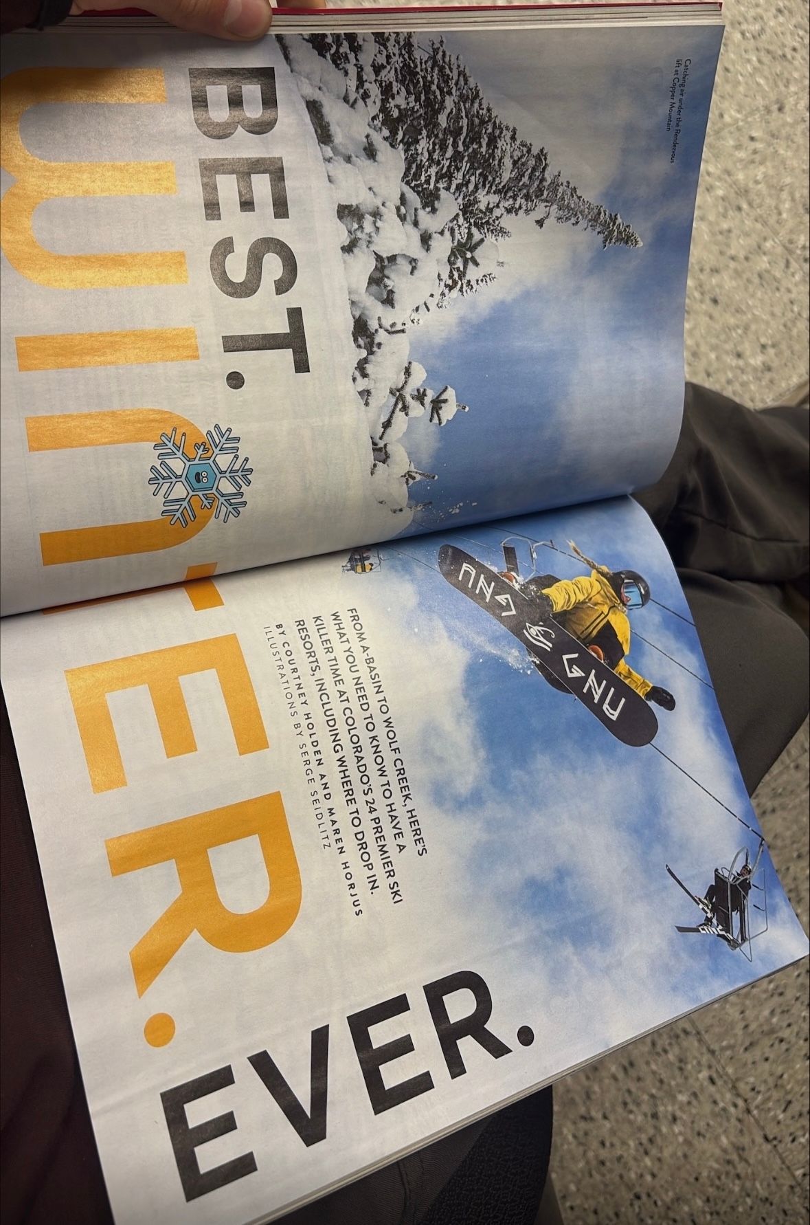 Open magazine pages showing blue sky with text and graphics in black and orange colors.