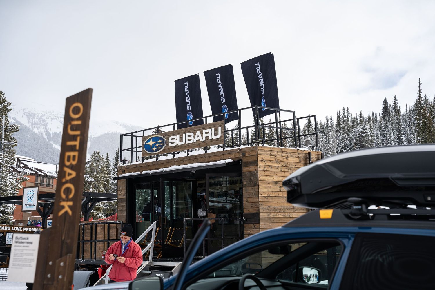 Subaru outdoor display setup with flags and branding at a winter sports venue.
