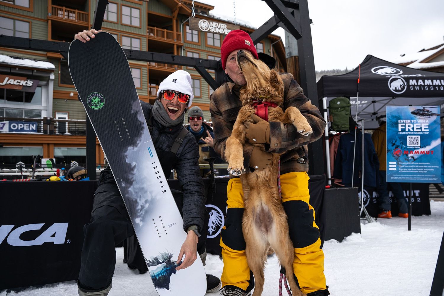 Skier posing with their equipment and a rescue dog at a winter sports event.
