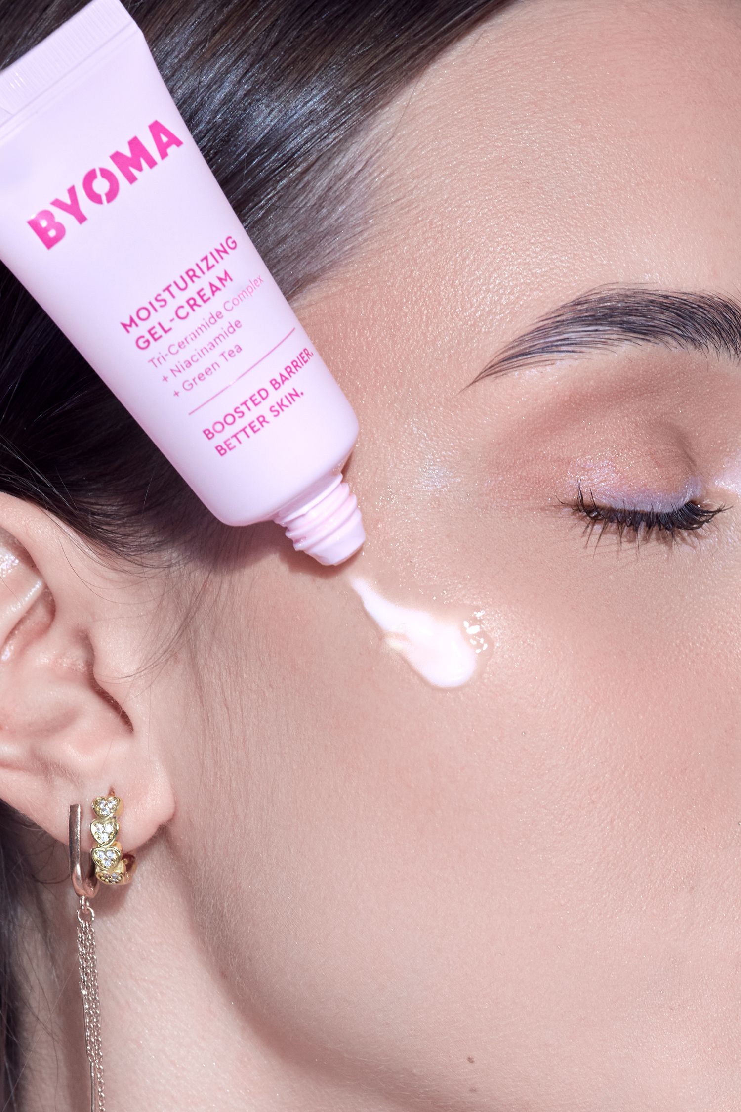 BYOMA Moisturizing Gel-Cream being applied to a woman's cheek, showcasing the product's lightweight texture.
