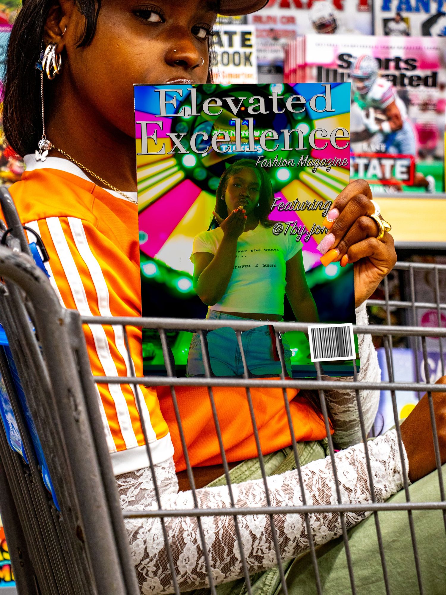 Young woman in shopping cart reads Elevated Excellence Fashion Magazine featuring OTay2ani in store.