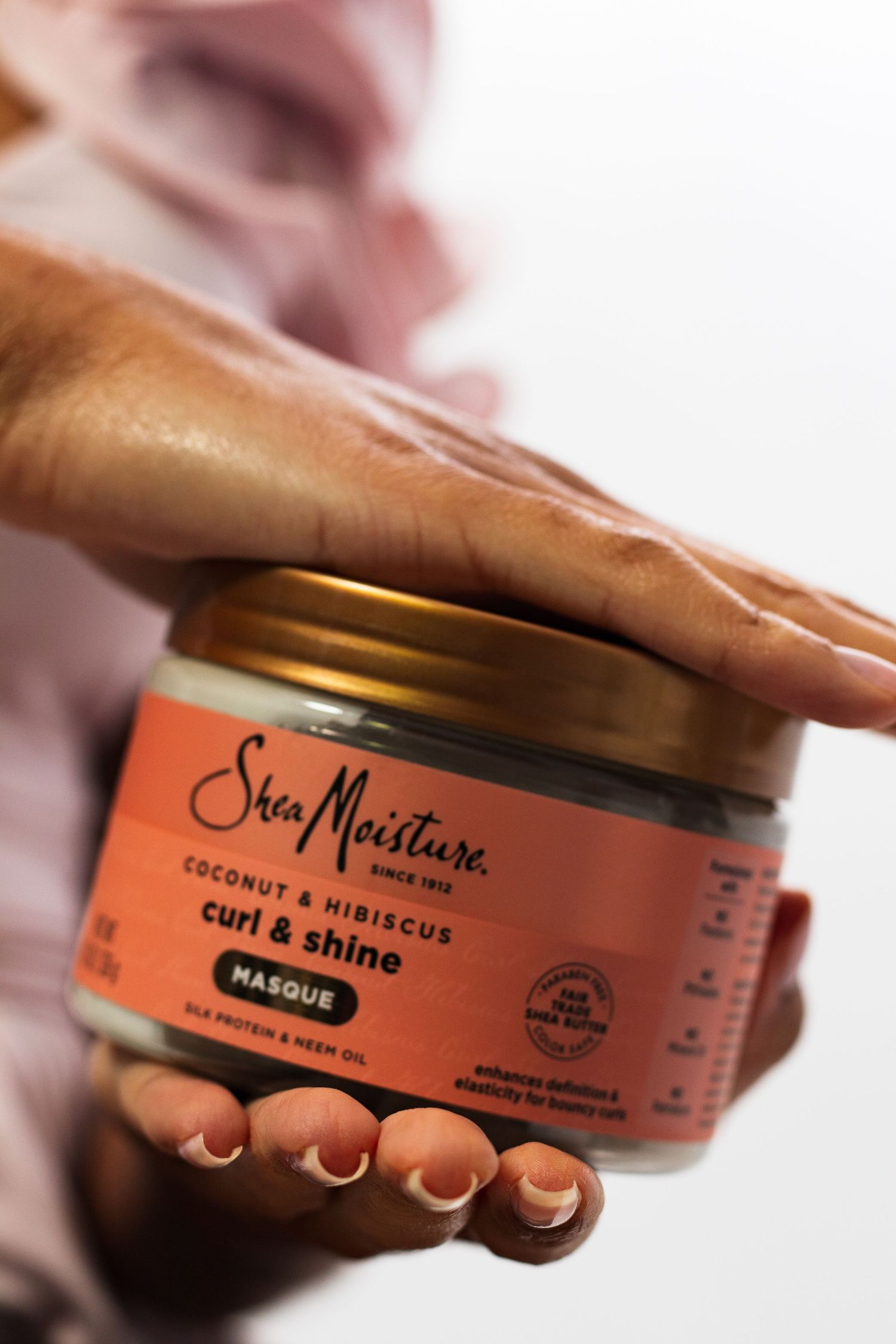 Close-up of SheaMoisture Coconut Hibiscus Curl Shine Masque being held.