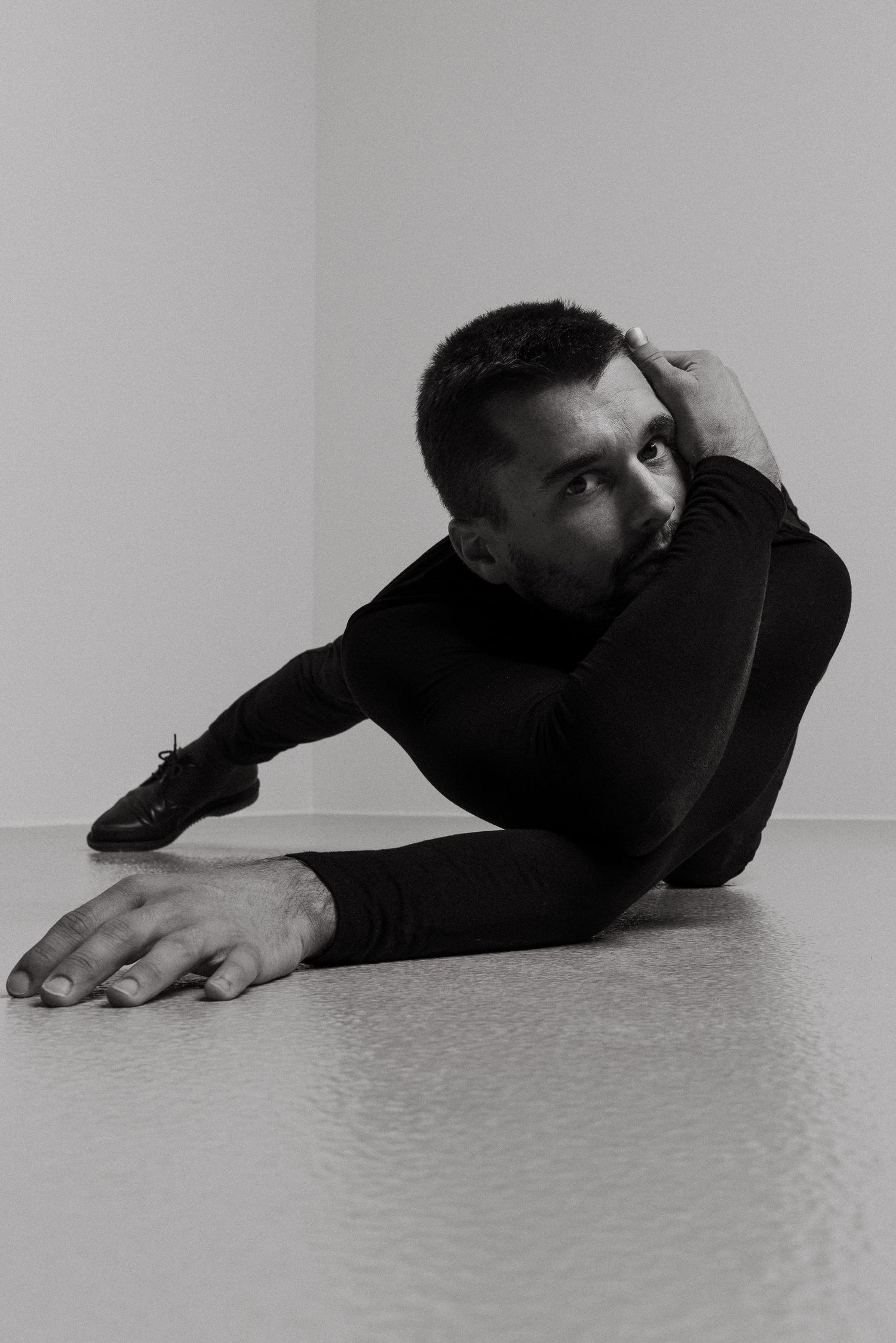 Black and white series of minimalist photographs showing a dancer in a fluid, progressive movement sequence.
