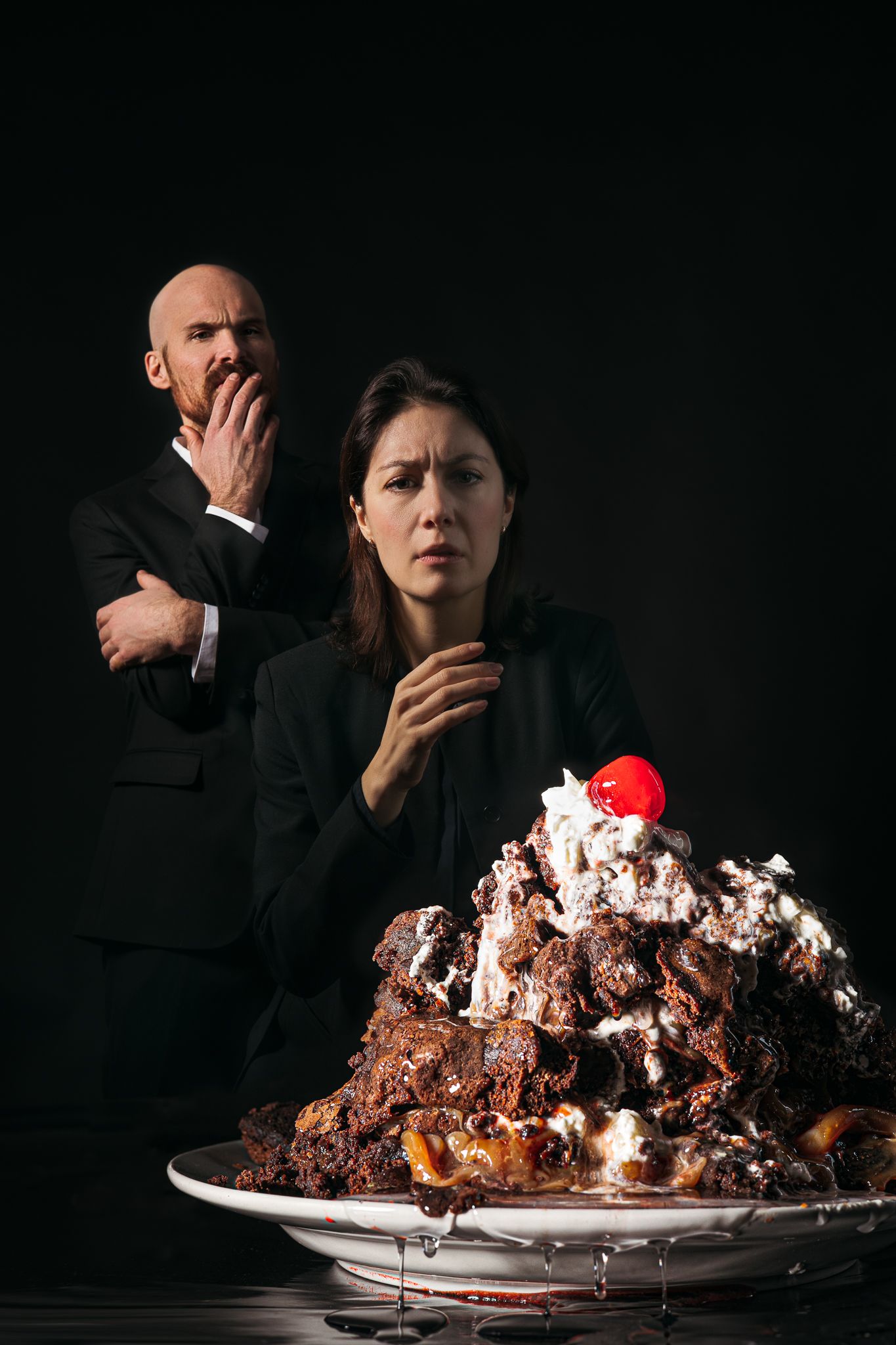 Dramatic sequence of emotional reactions to a decadent dessert on a dark background.