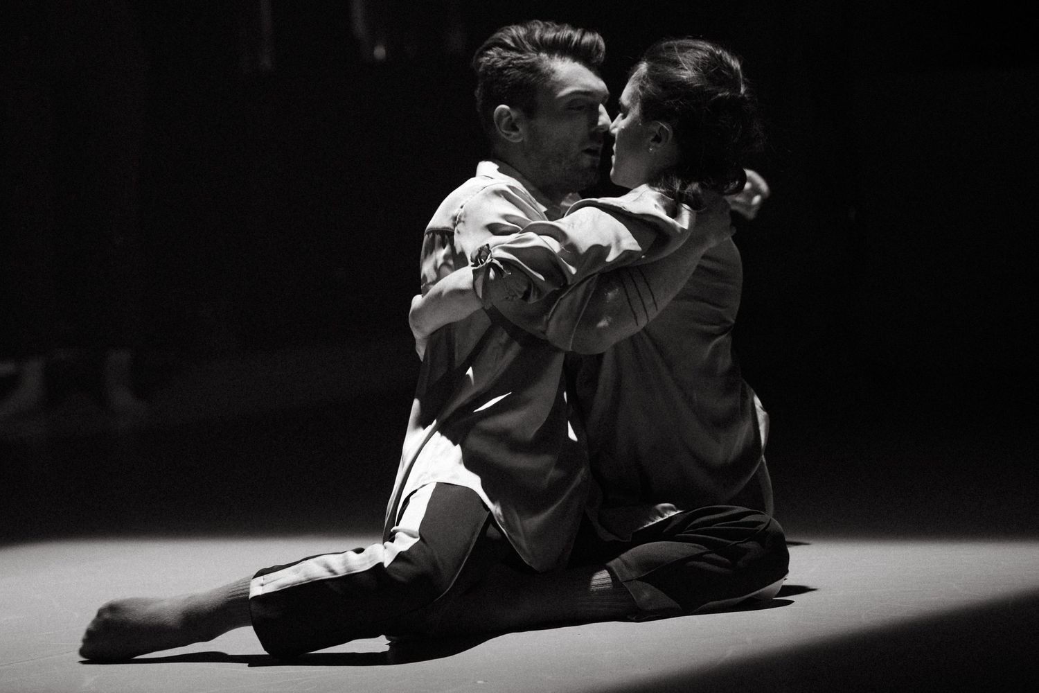 Artistic black and white photos of martial artists performing grappling moves in sequence.