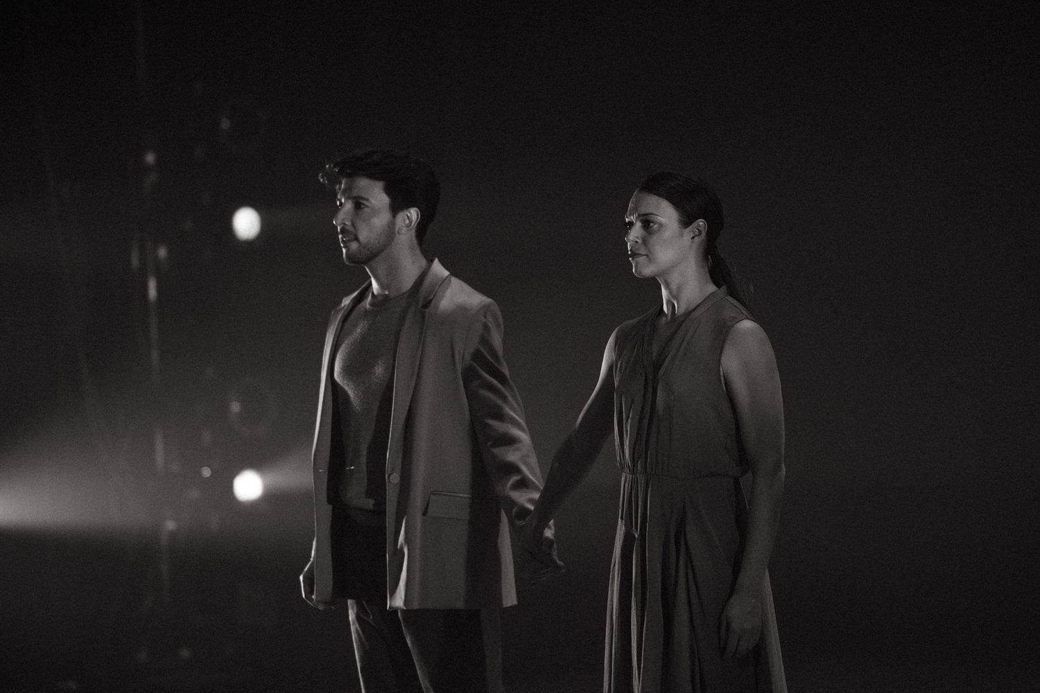 A film noir style sequence of black and white performance stills showing people in dramatic lighting.