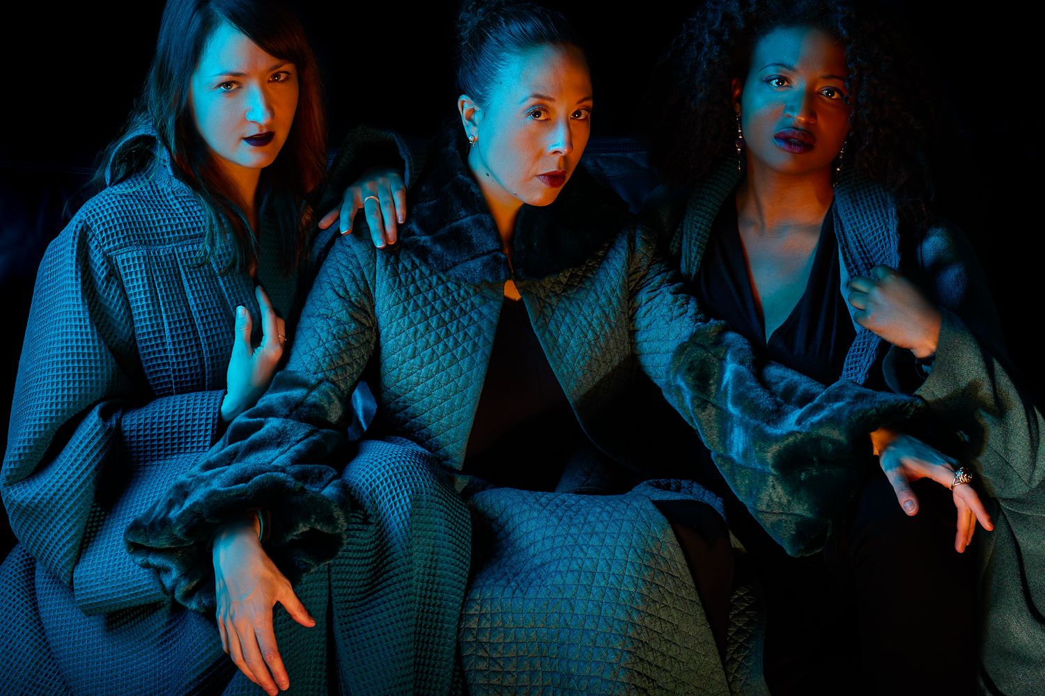 A dark and moody sequence of blue-tinted photographs showing people in dramatic poses and lighting effects.