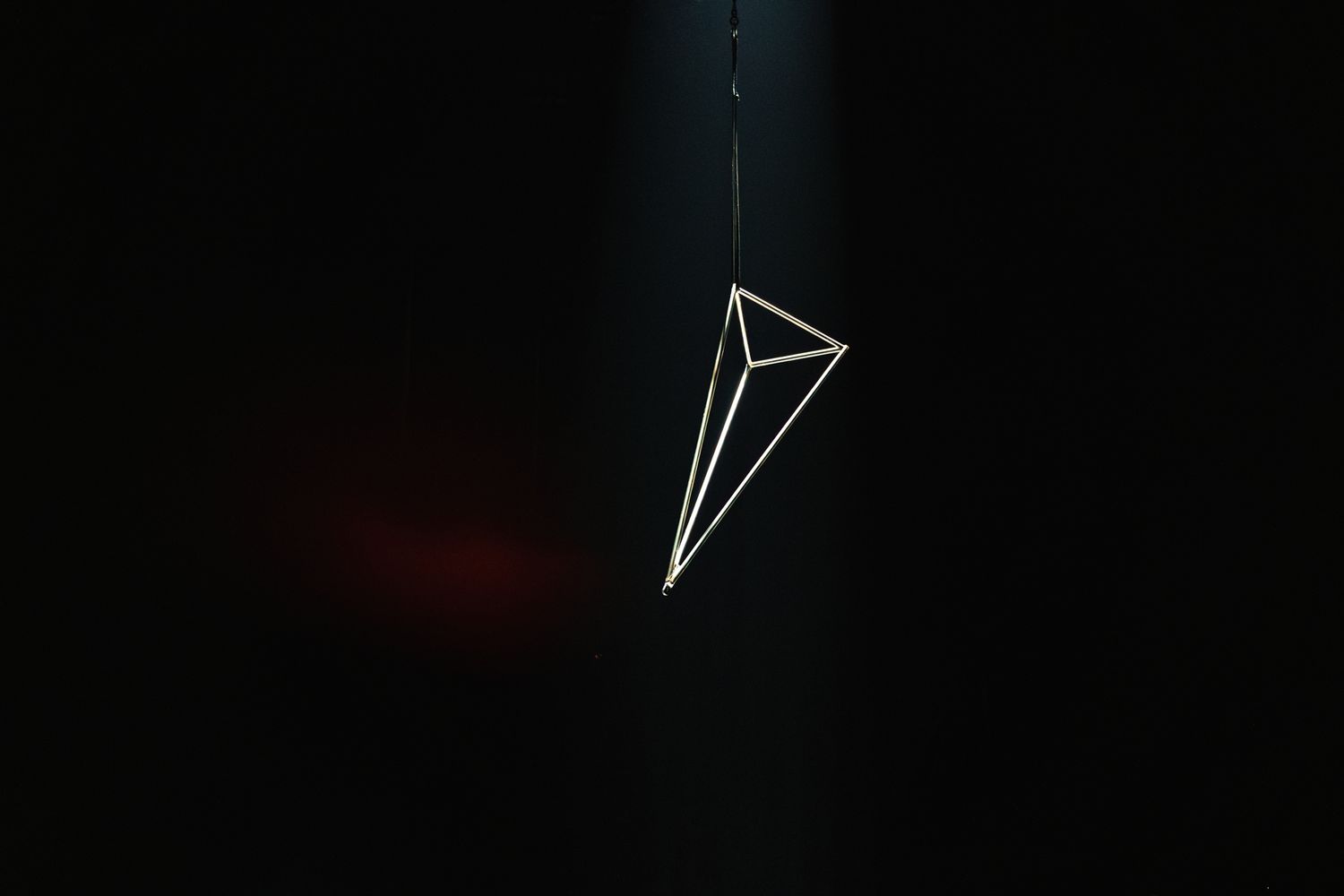 Minimalist geometric arrows design in white on a dark background in sequential display.