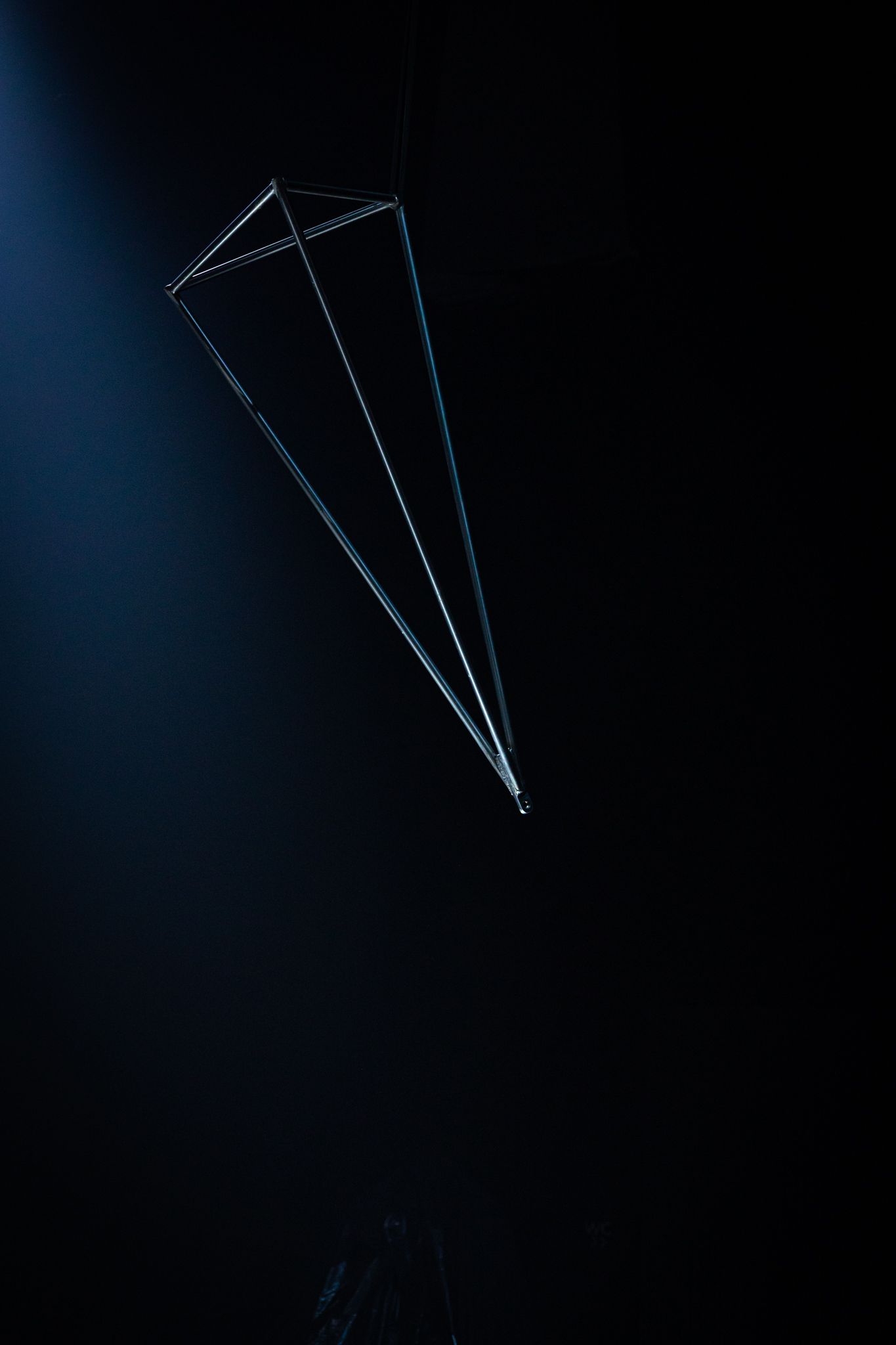 A falling paper airplane silhouette against a dark background creates a dynamic motion trail effect.