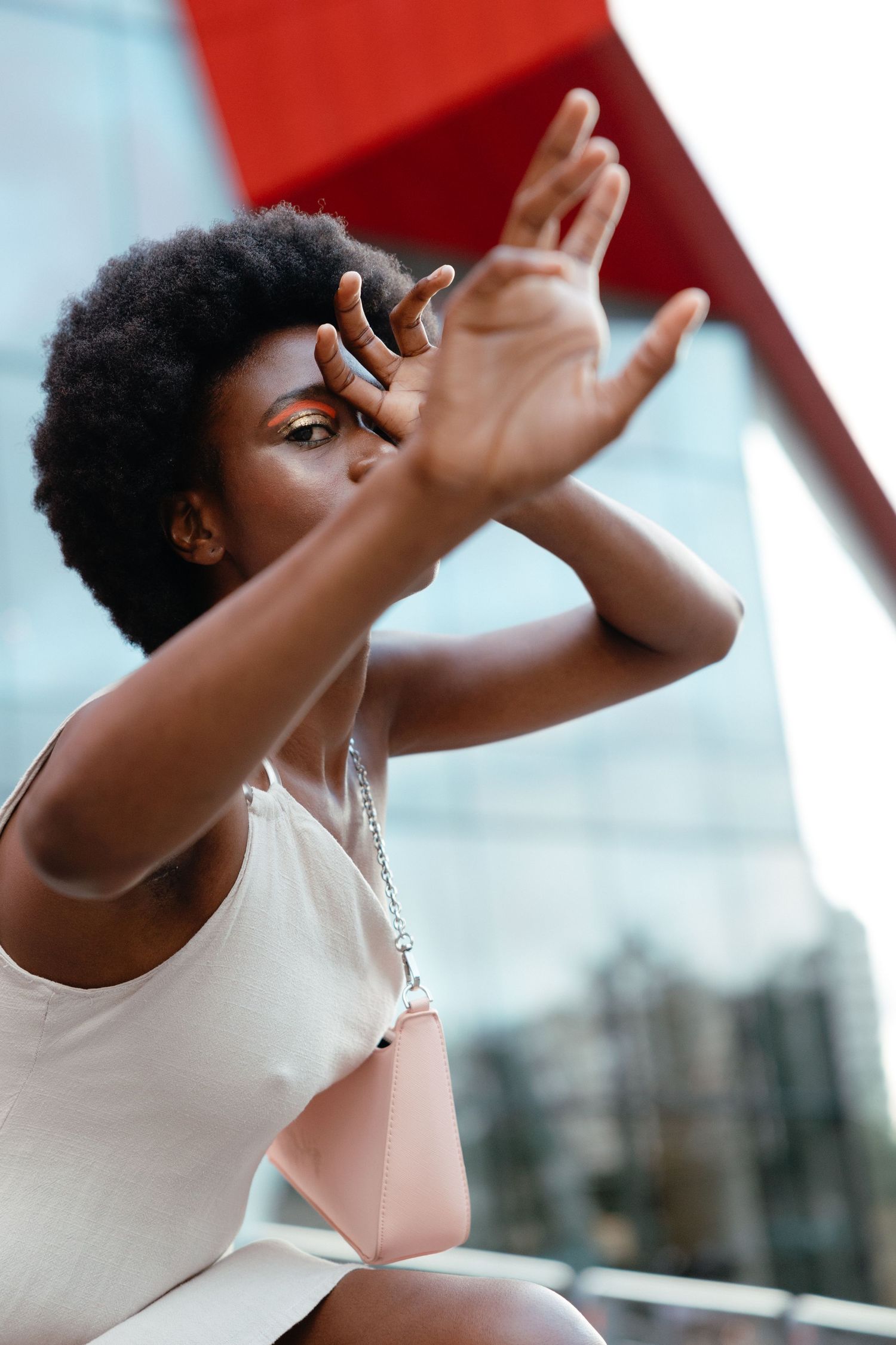 Three sequential photos show a woman in white dancing with expressive arm movements against a blurred background.