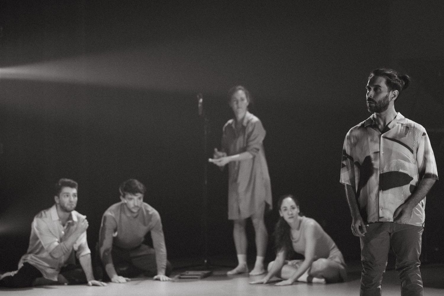 A series of black and white photos showing gymnasts practicing and performing stretches and exercises.