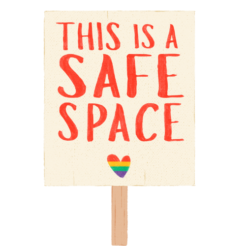 A protest sign reading 'THIS IS A SAFE SPACE' in red capital letters with a rainbow heart symbol at the bottom.