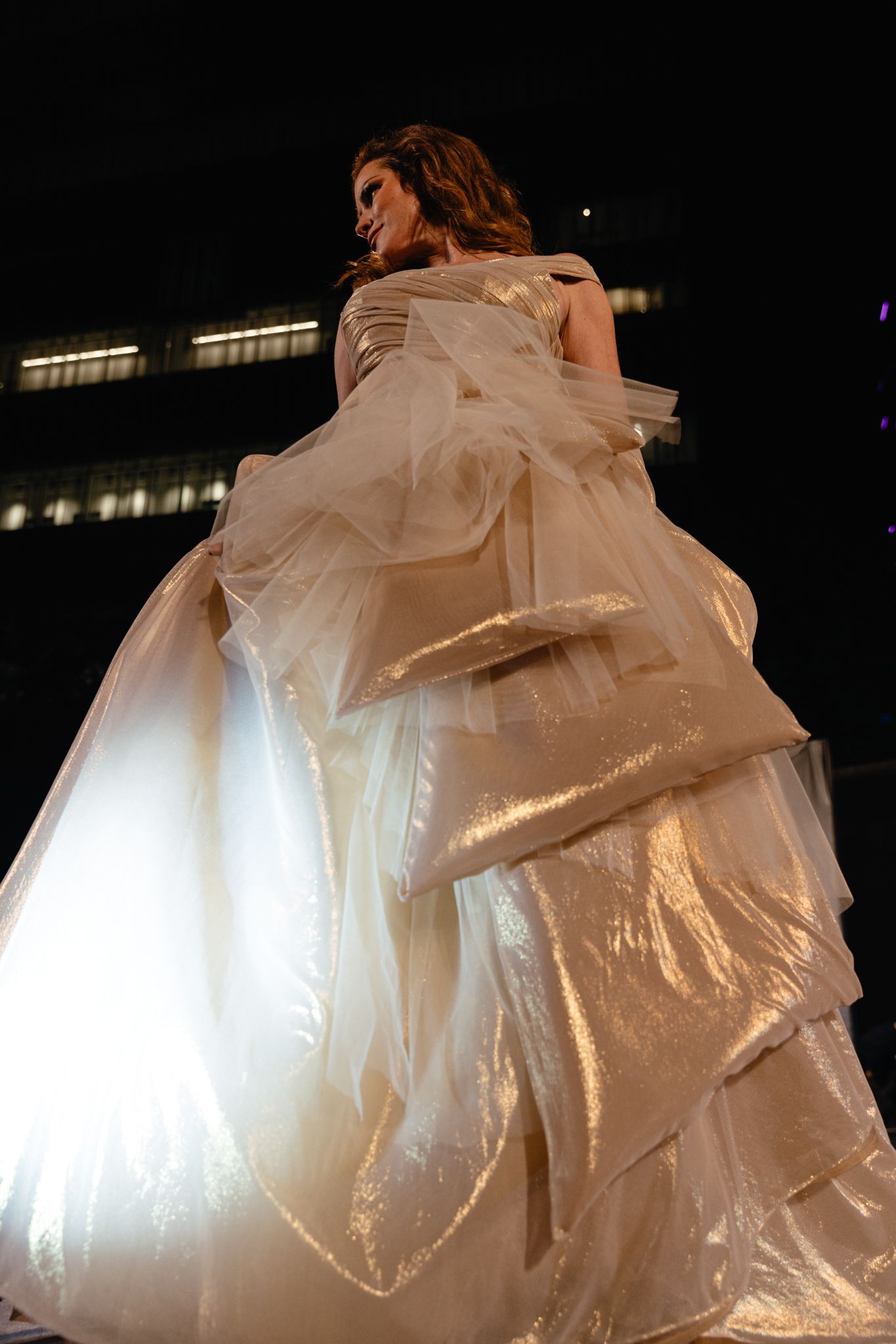 Dance performance featuring flowing white fabric billowing dramatically against a dark background.