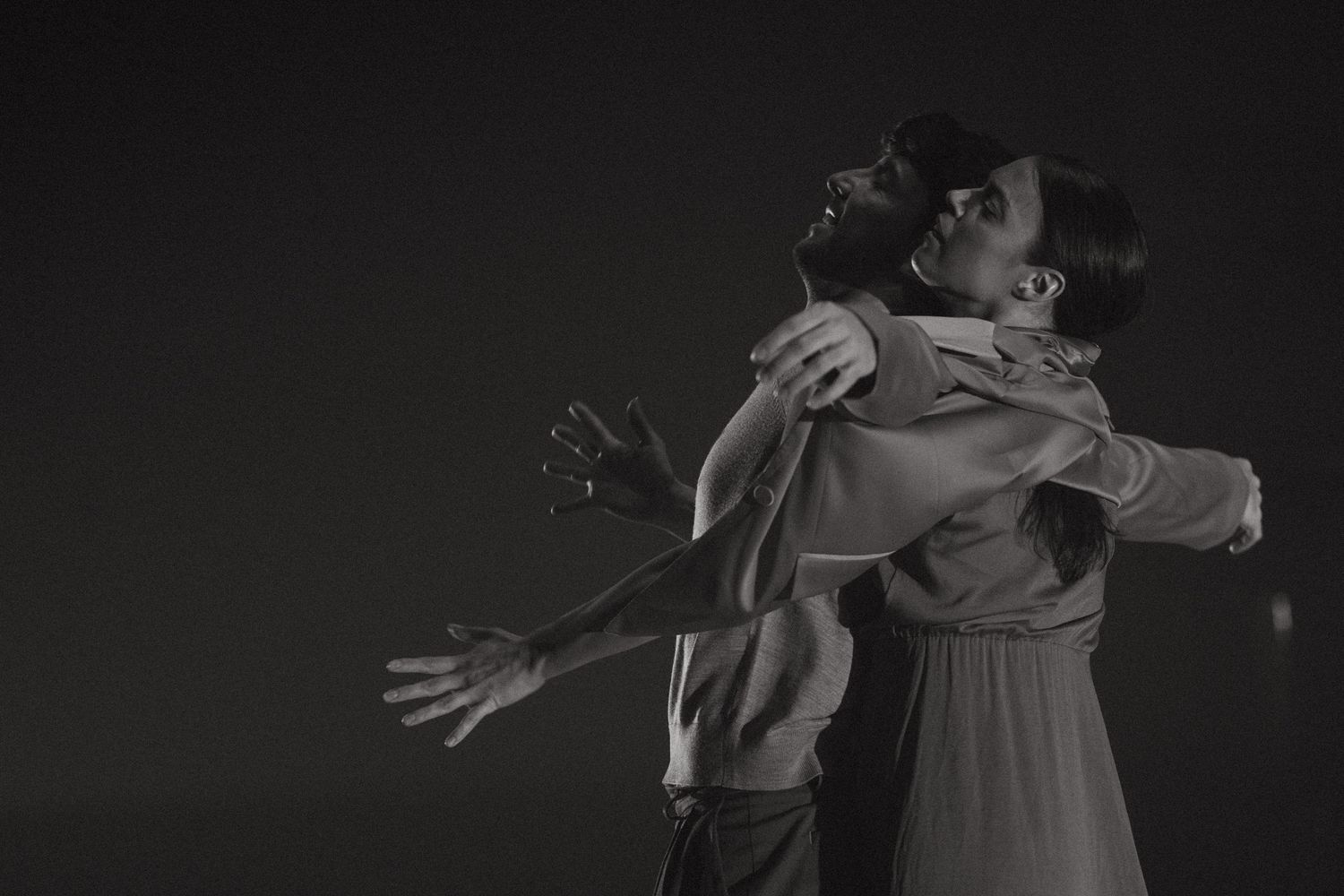 A dramatic black and white photo series showing the poetic movements of a dancer performing in a dress.