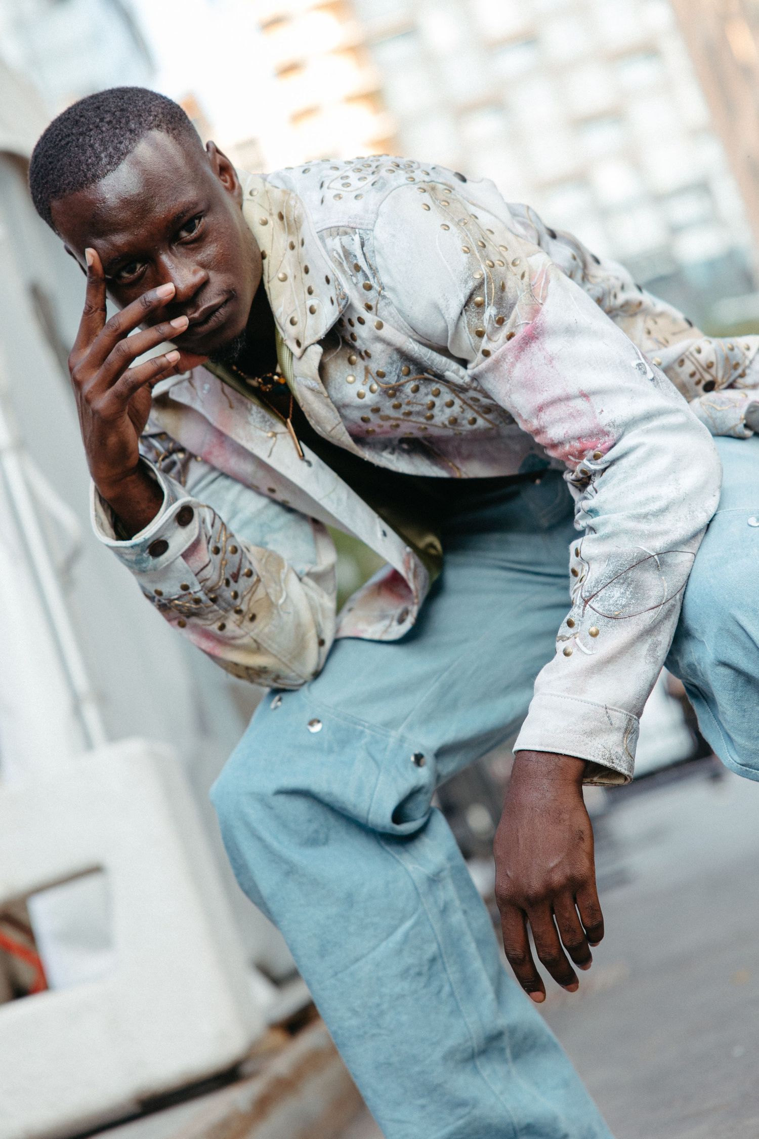 A sequence showing a person in a floral jacket and blue pants expressing emotion across four similar poses.