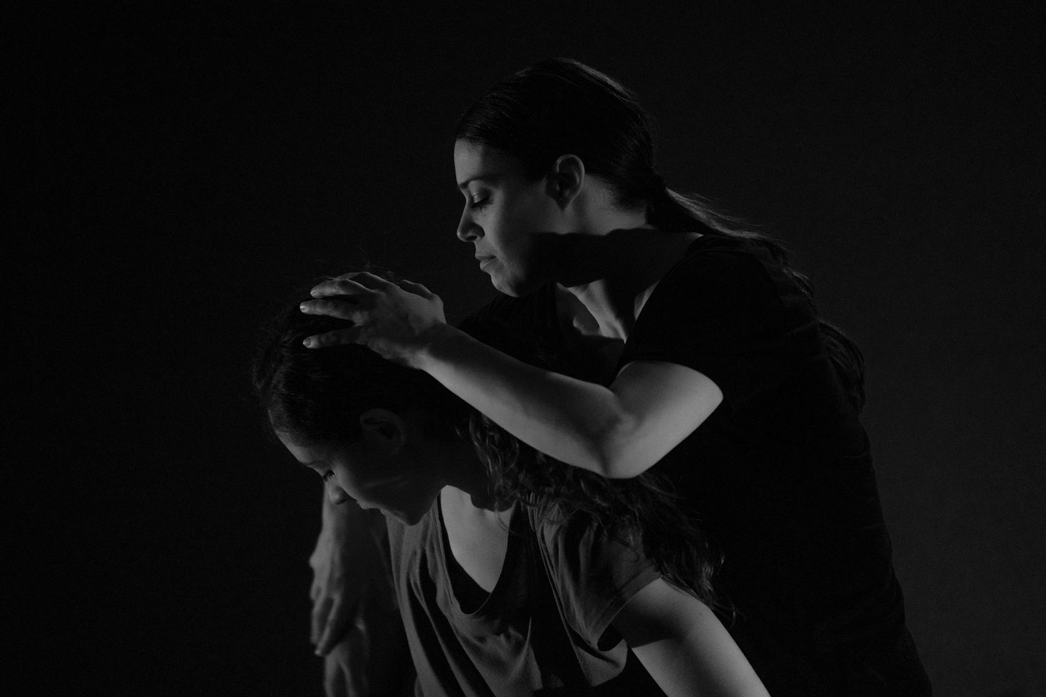 A black and white abstract sequence showing movement and dance against a dark background.