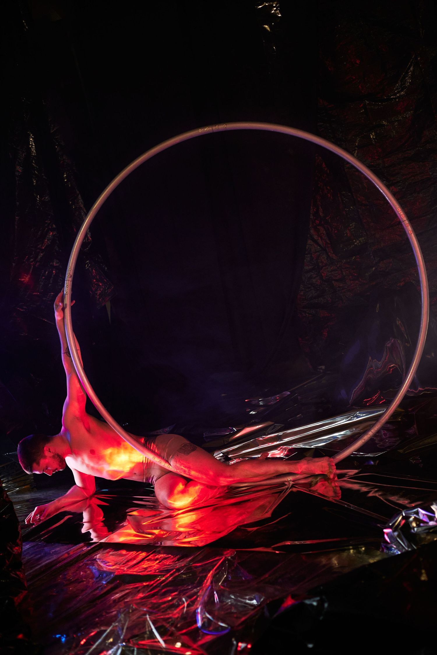 Dynamic red light trails swirl against a dark background creating an abstract glowing pattern in motion.