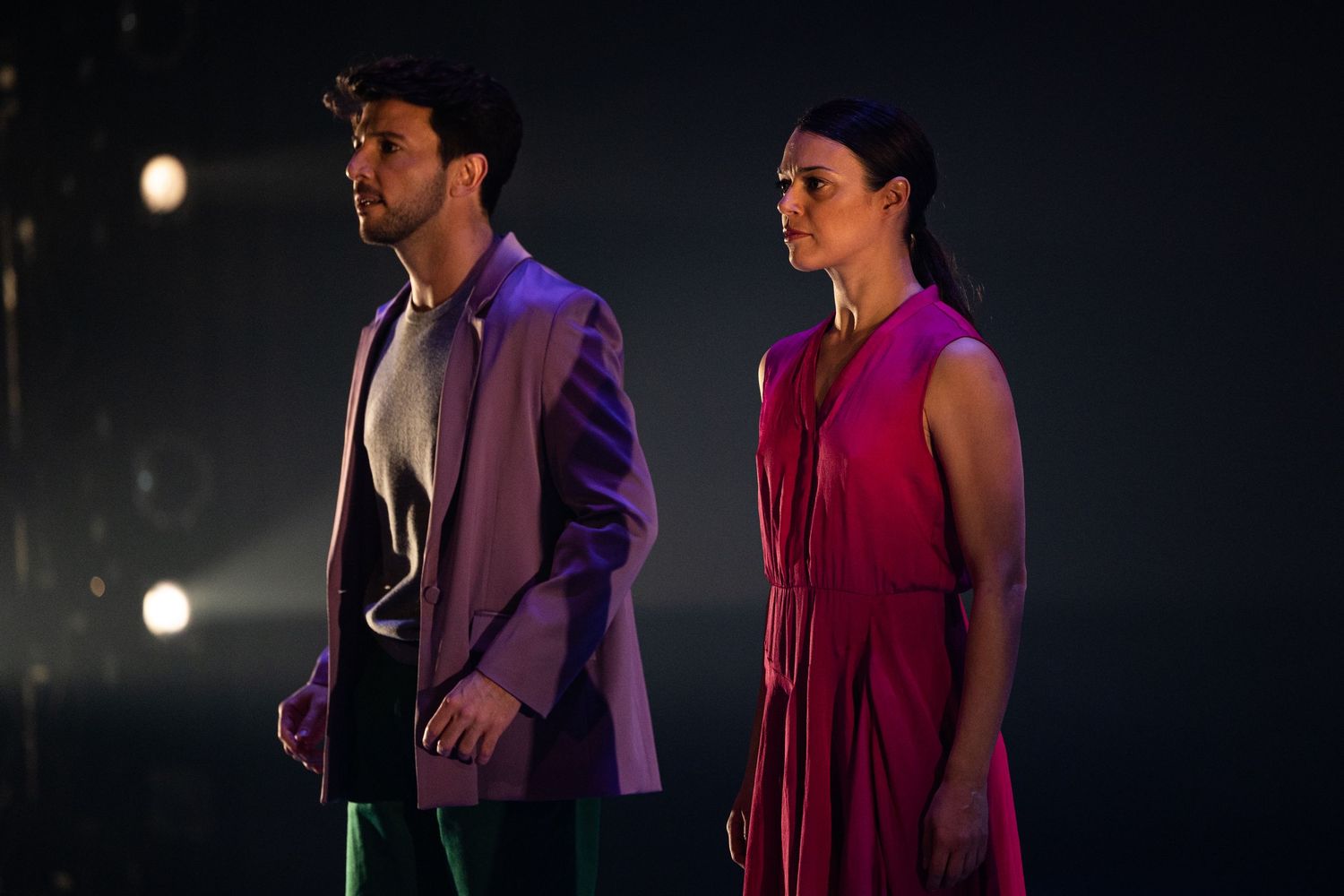 A sequence of dark theatrical scenes lit in purple and burgundy tones showing performers on stage during a show.