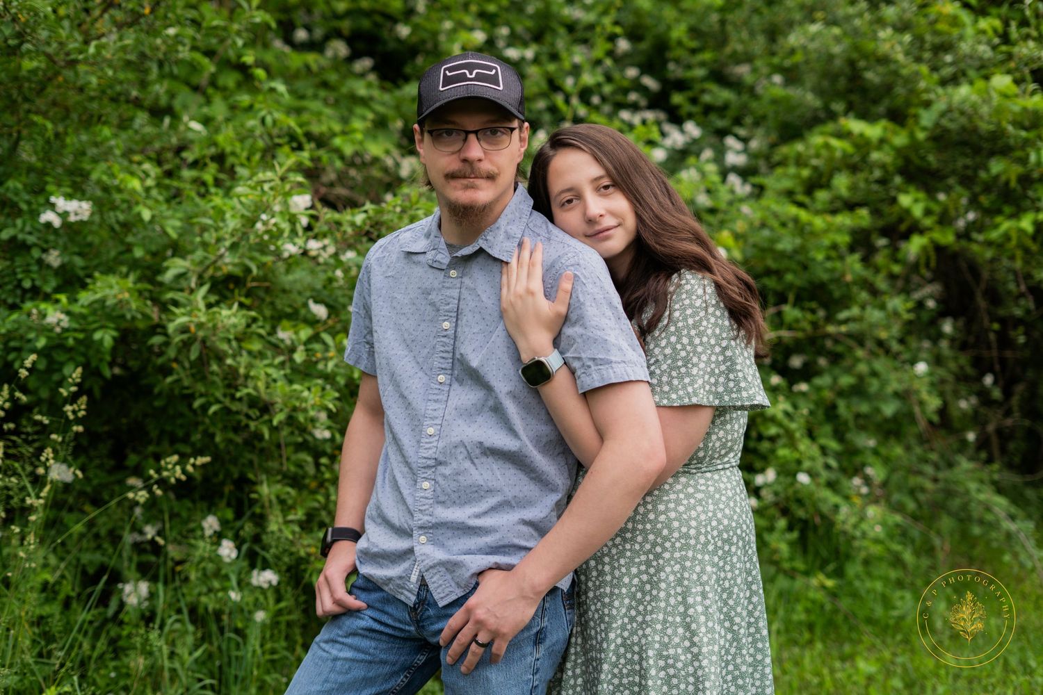 Romantic couple portraits in a lush green garden setting during spring or summer.