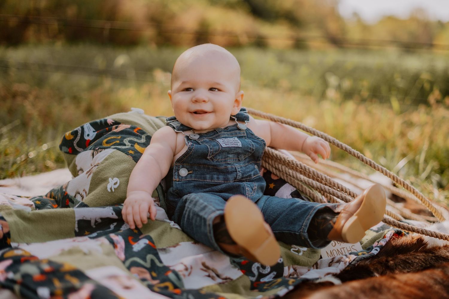 Baby lying on blanket during outdoor lifestyle photography session.