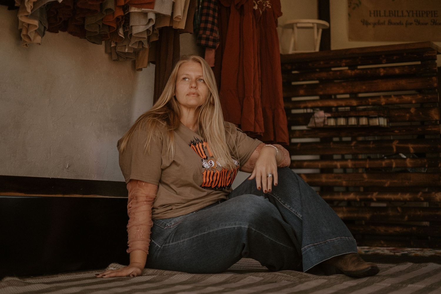A cozy indoor photoshoot with rustic brick walls and warm lighting.