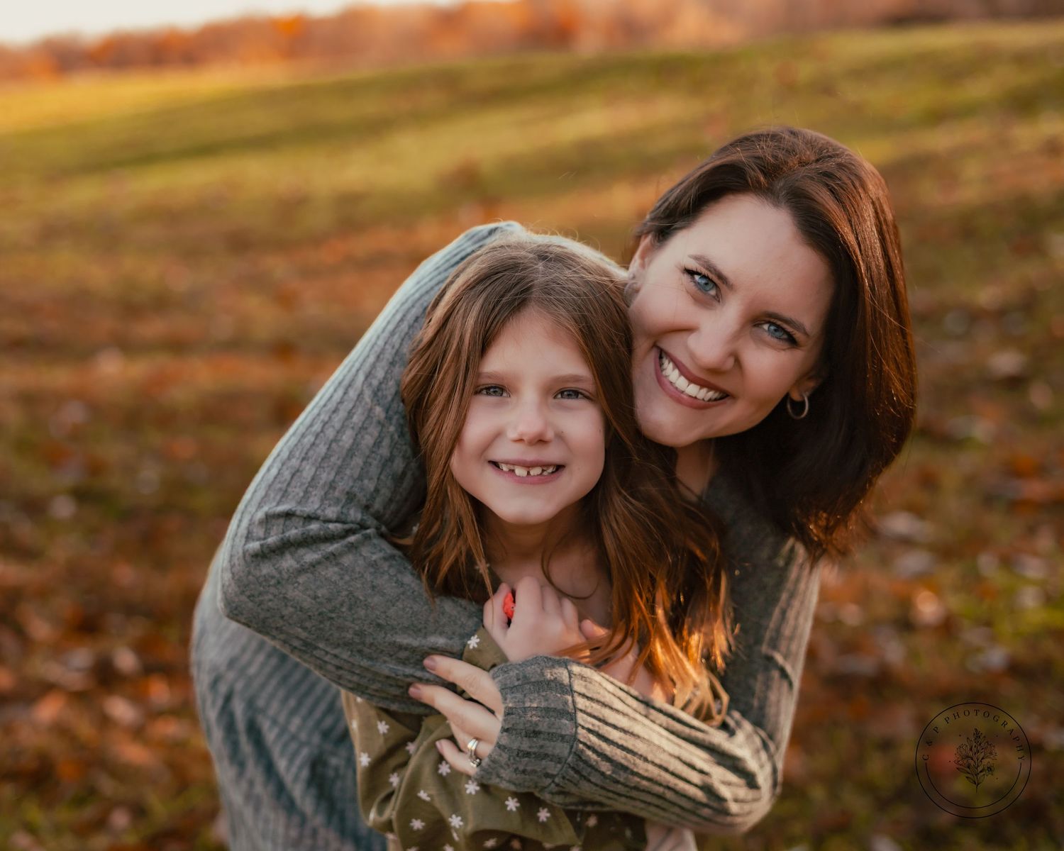 Warm autumn portrait session showing affectionate moment outdoors.