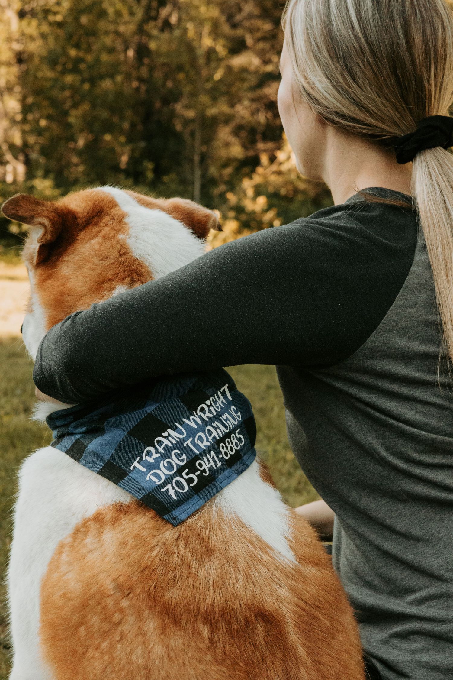 A series of photos showing a dog wearing a blue embroidered bandana being hugged by someone in a gray sweater.