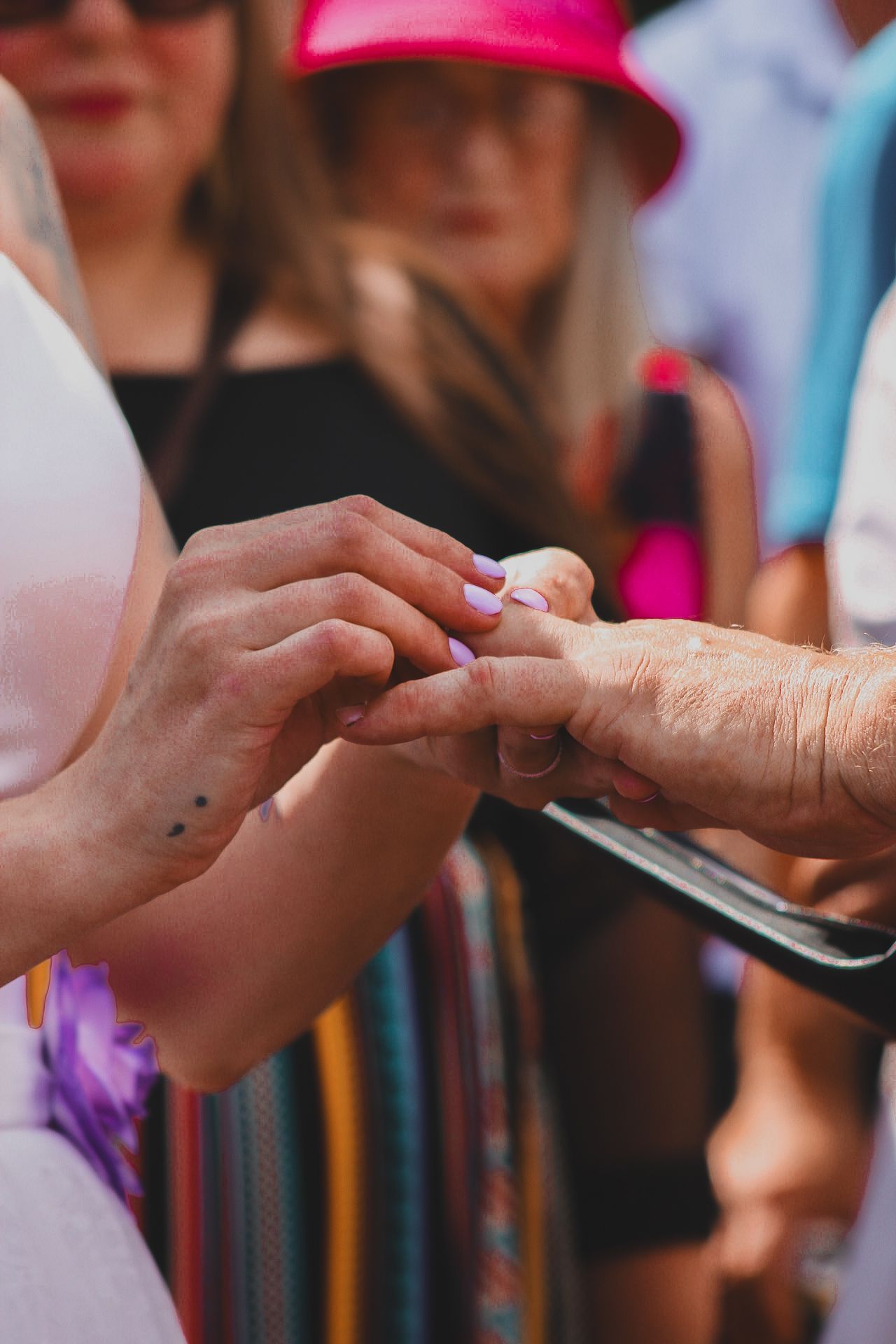 People pass a phone through a crowd displaying the connected nature of social media and digital communication.