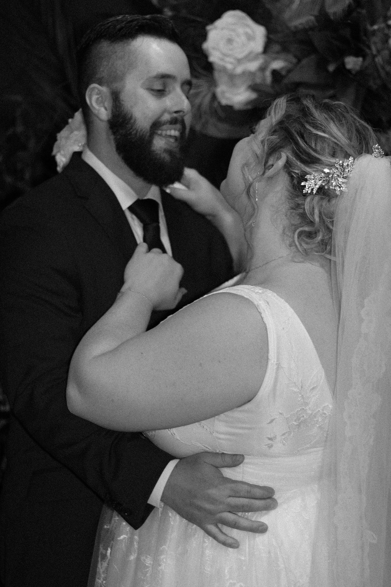 Black and white intimate moment between newlyweds during their wedding celebration.