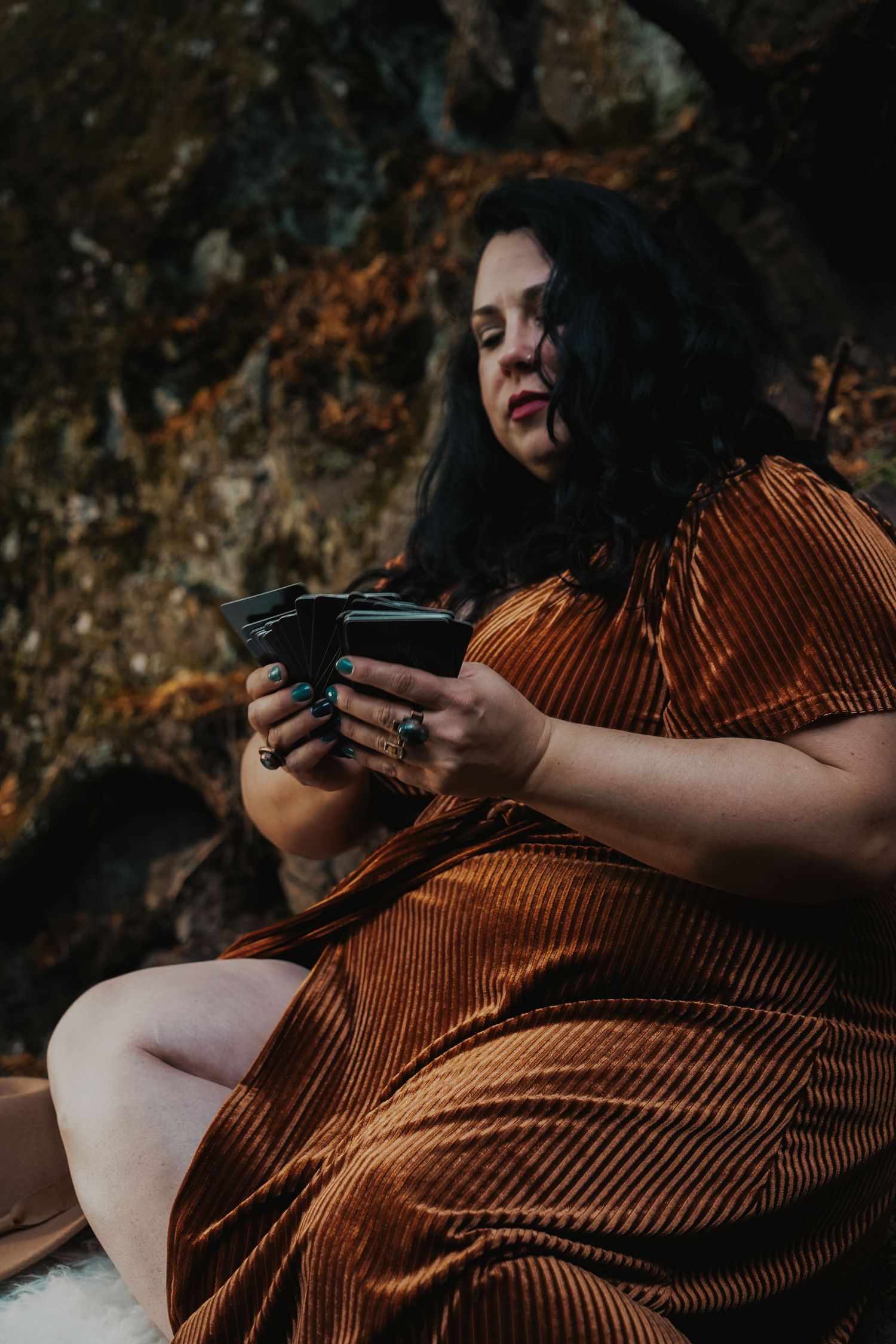 A series of cropped photos showing hands holding a retro film camera against warm autumn tones and weathered rocks.