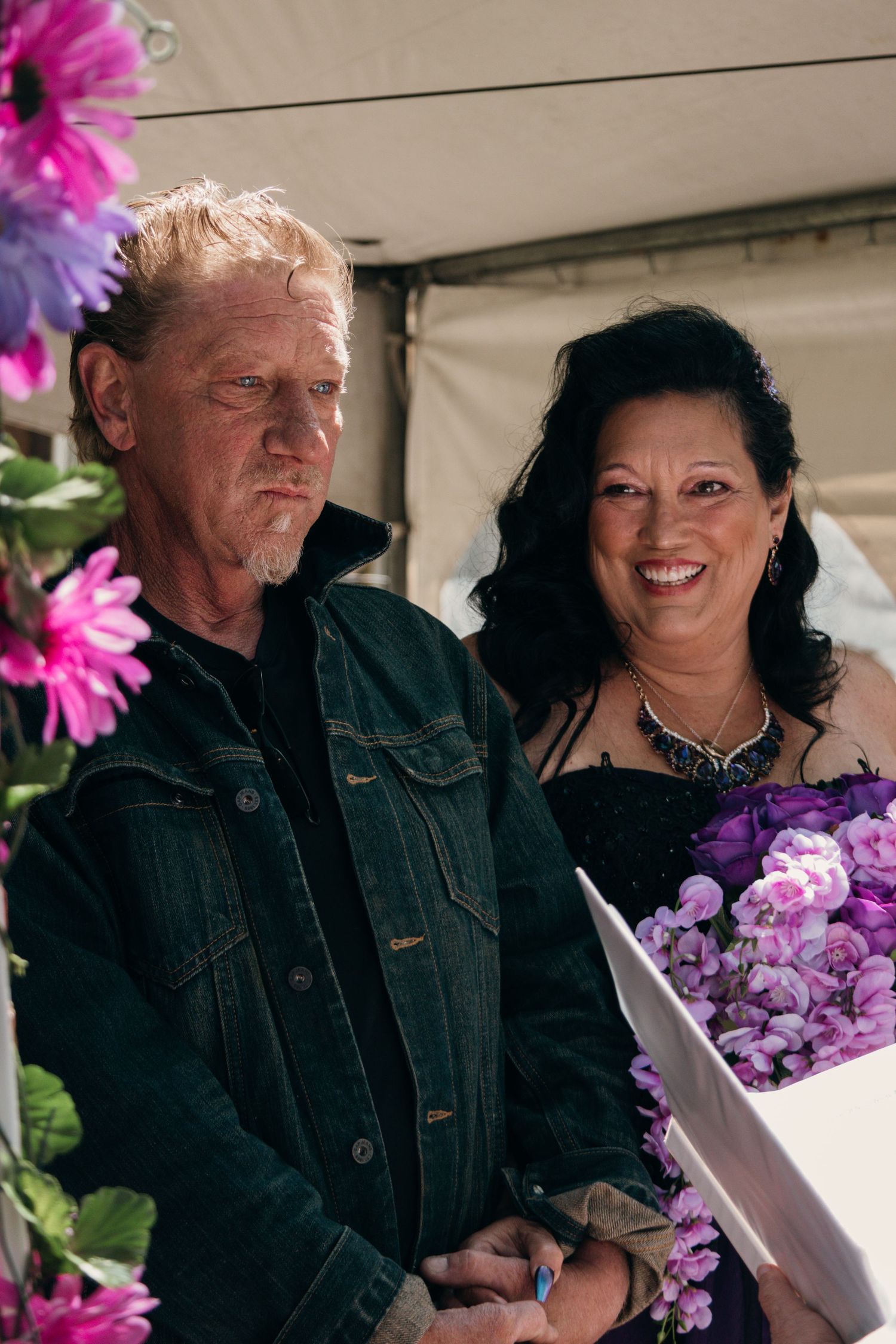 A series of candid moments showing two people sharing warm interactions surrounded by pink and purple flowers.