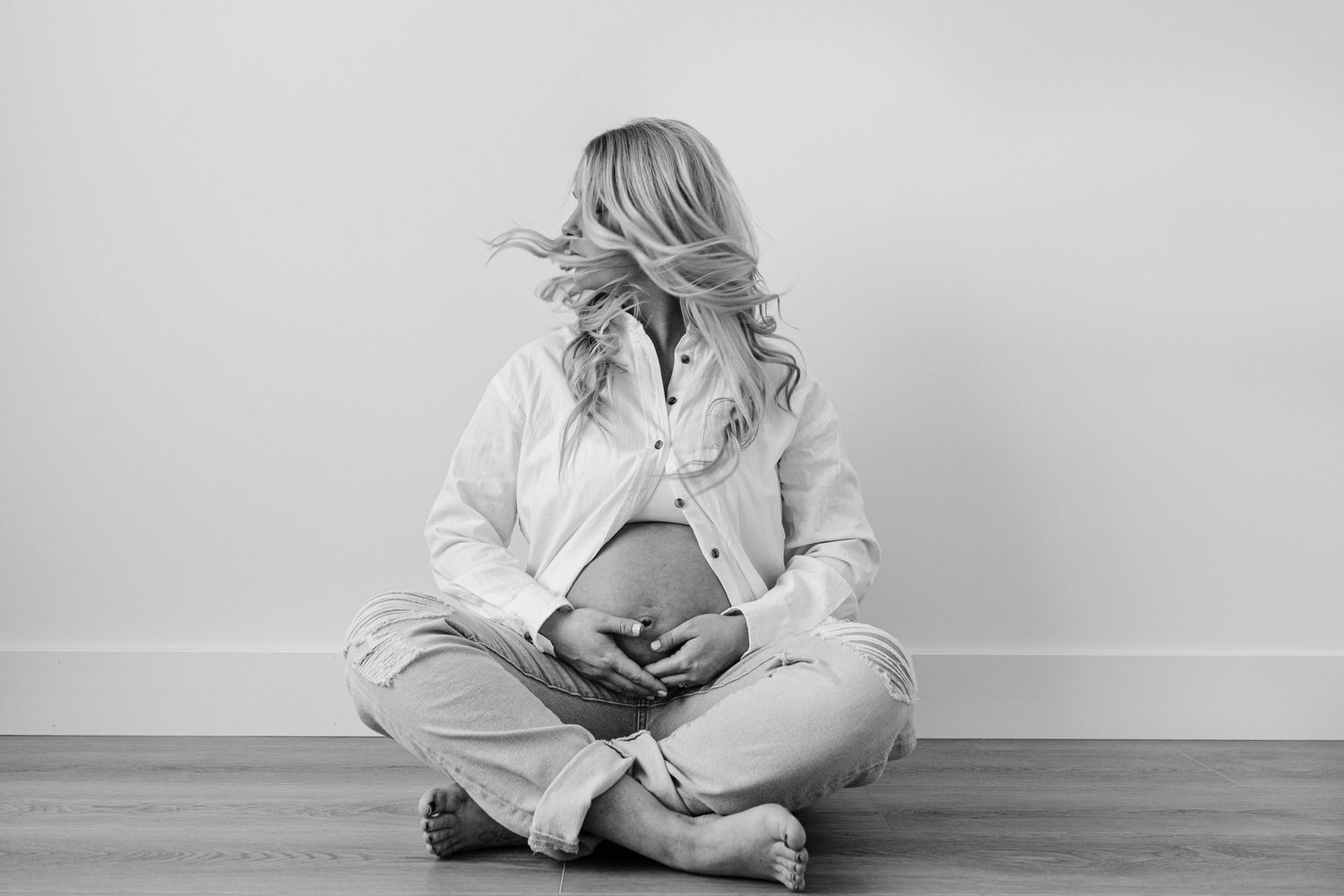 Artistic black and white maternity photography session showing intimate moments.