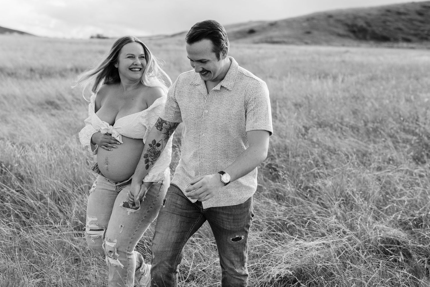 Black and white maternity portraits captured in a natural outdoor setting.