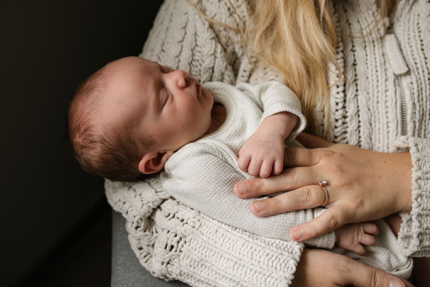 An intimate moment captured in soft lighting with a cream knit sweater.