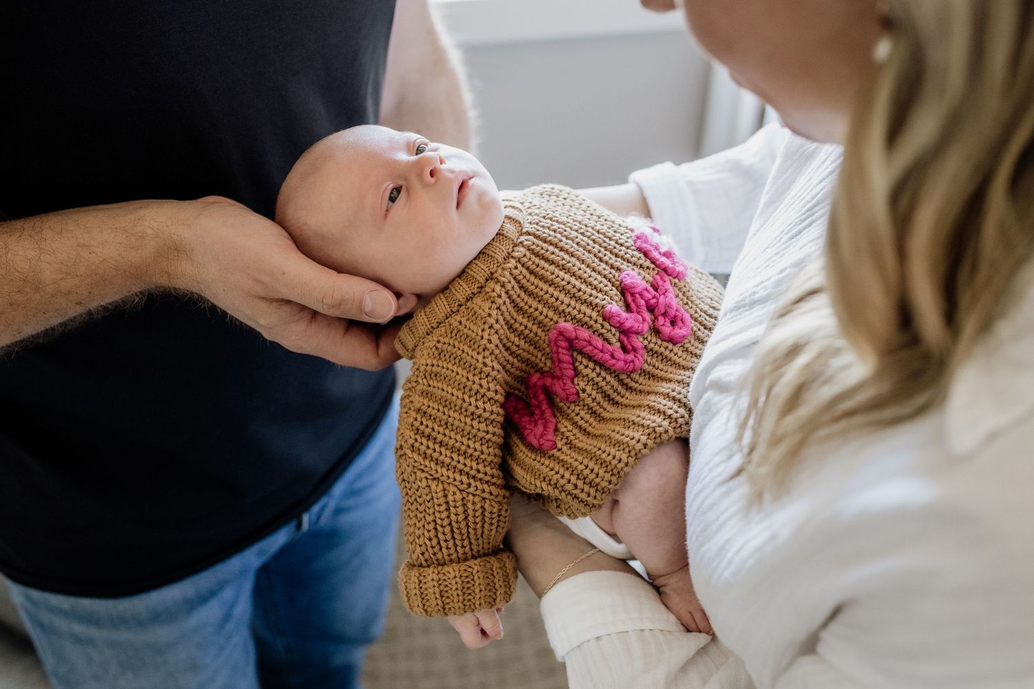 A gentle nursing moment captured in soft natural light.