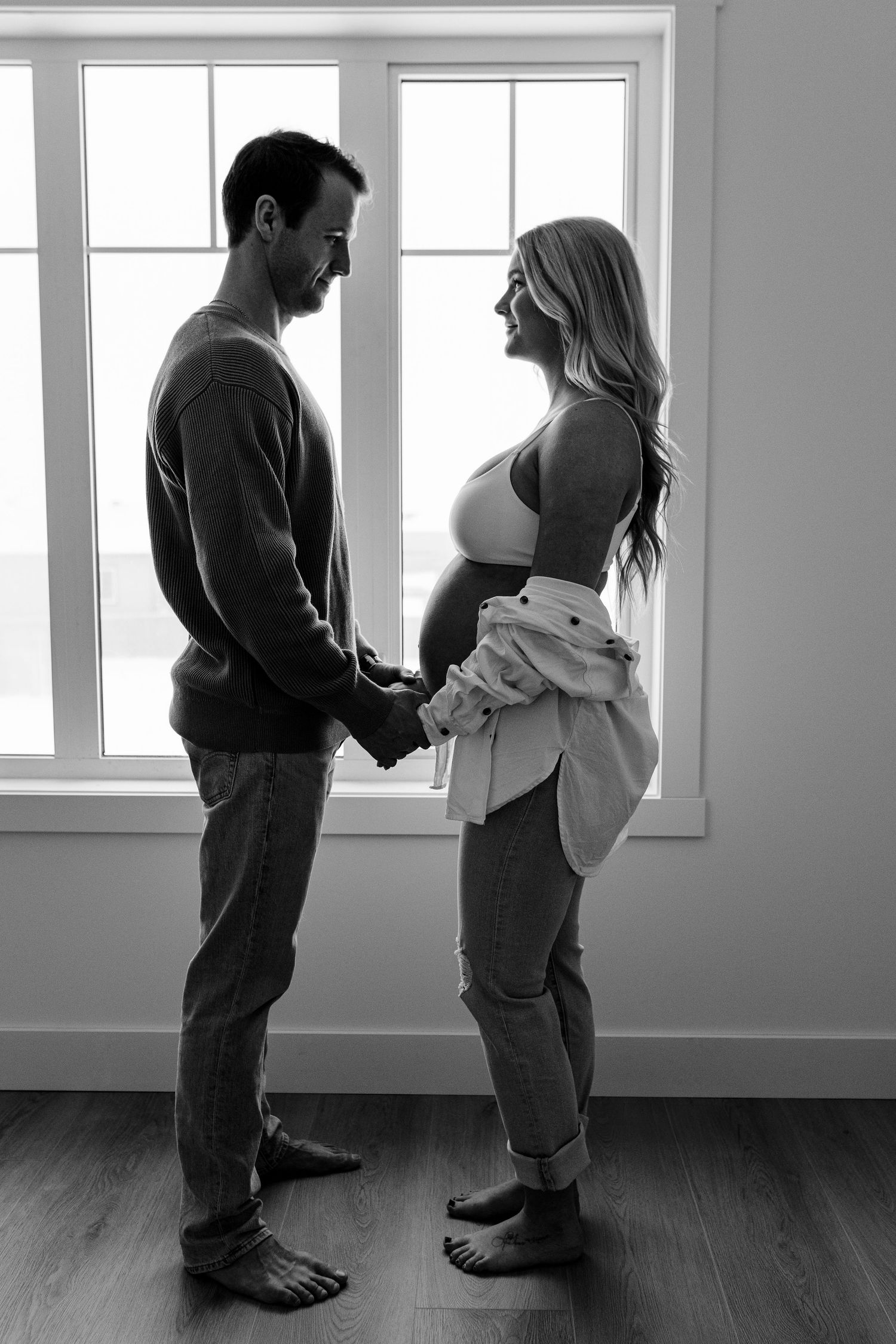 Series of minimalist photos showing two people standing together in a bright room.