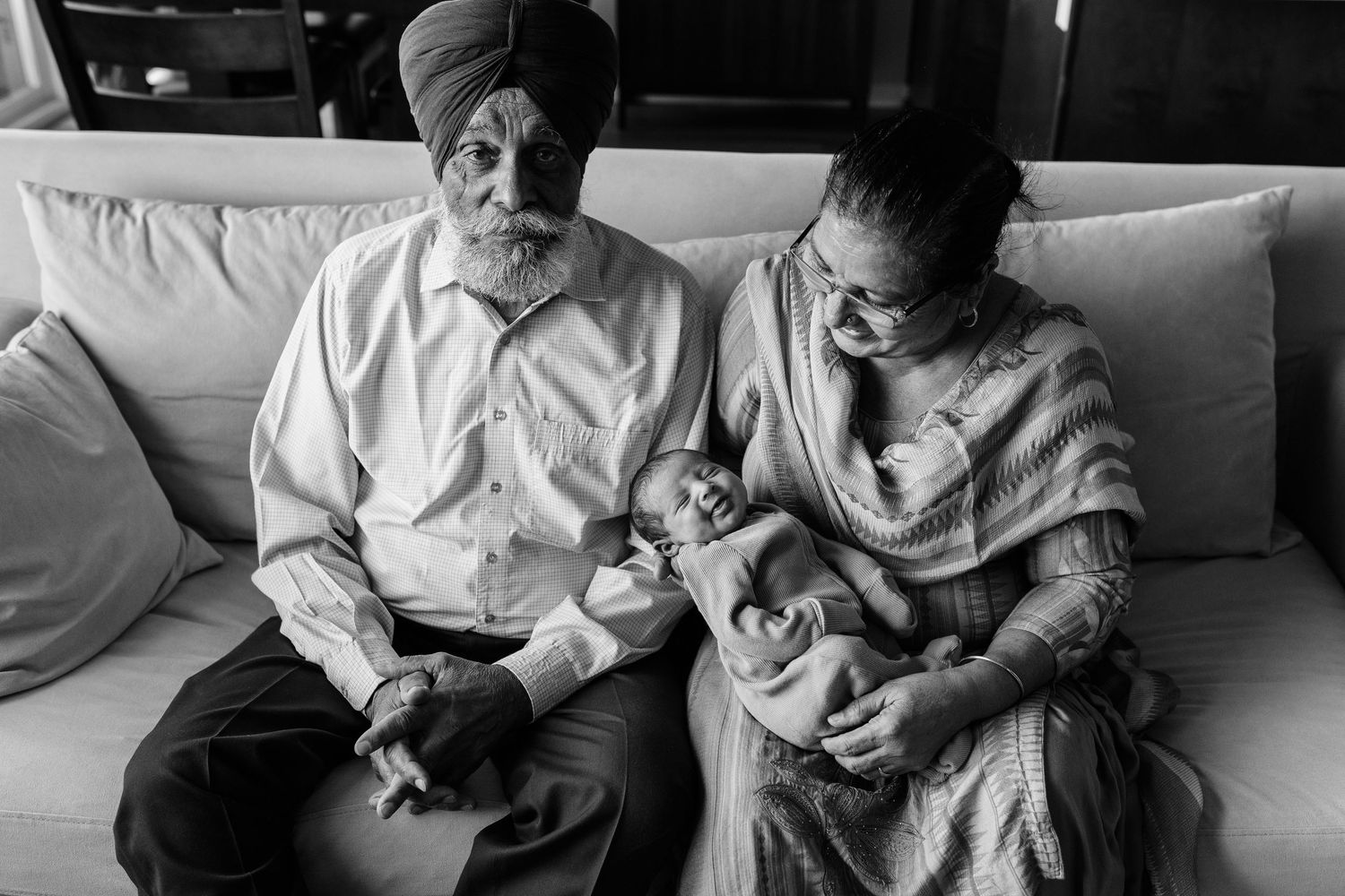 A tender family moment captured in black and white photography.