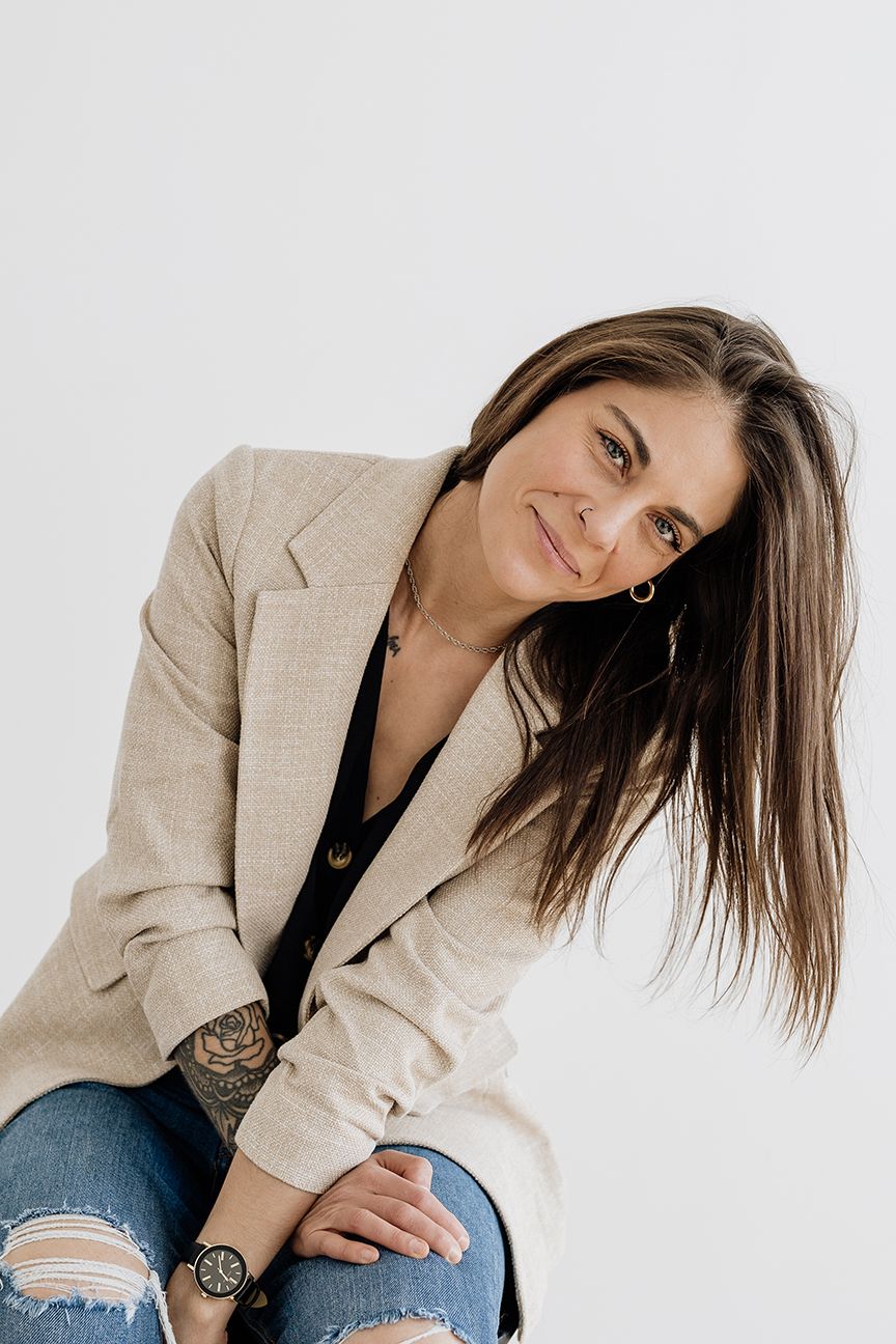 Professional fashion portraits featuring a beige blazer and distressed jeans in a minimalist studio setting.