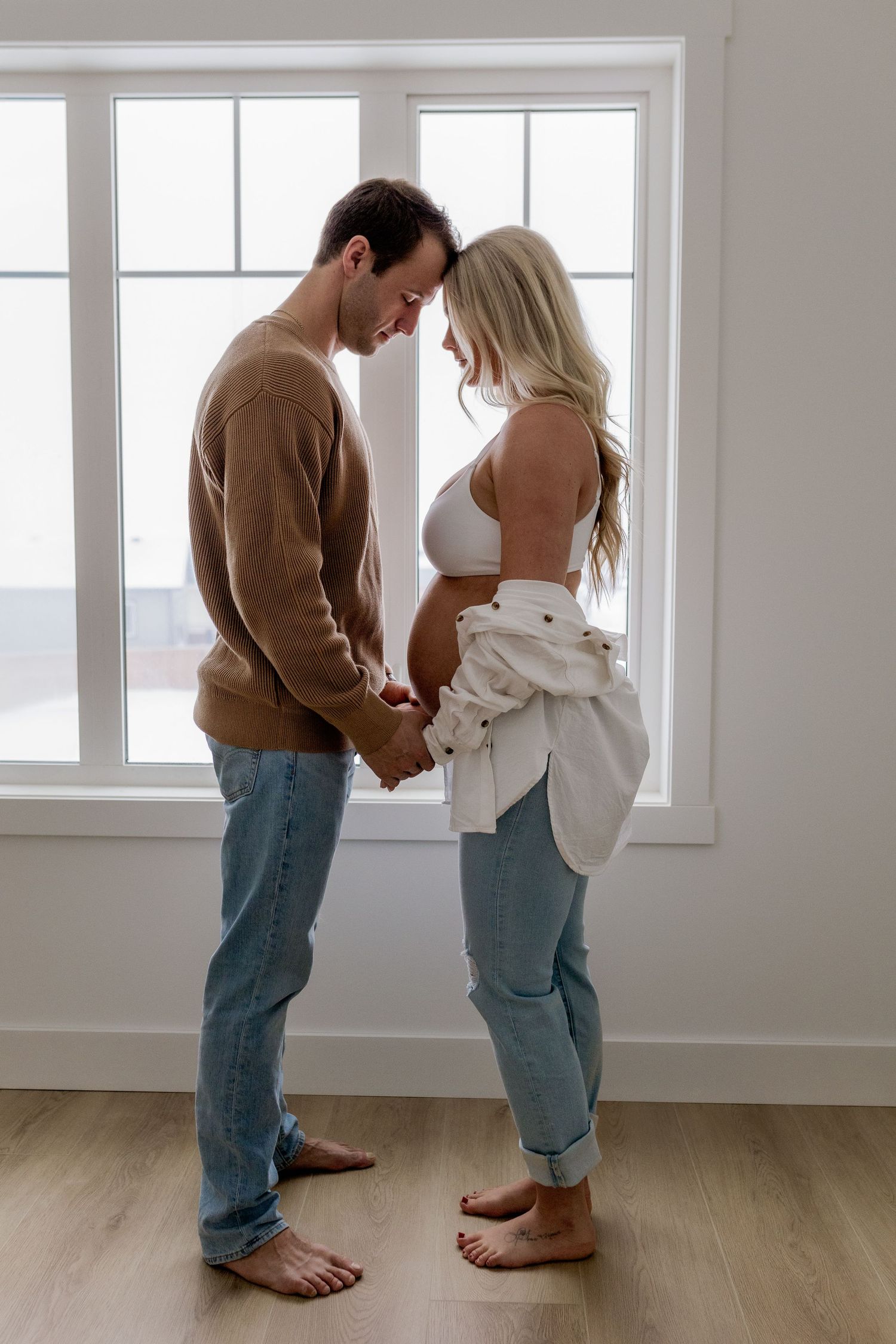 Series showing two people in casual attire standing together in a bright minimalist space.