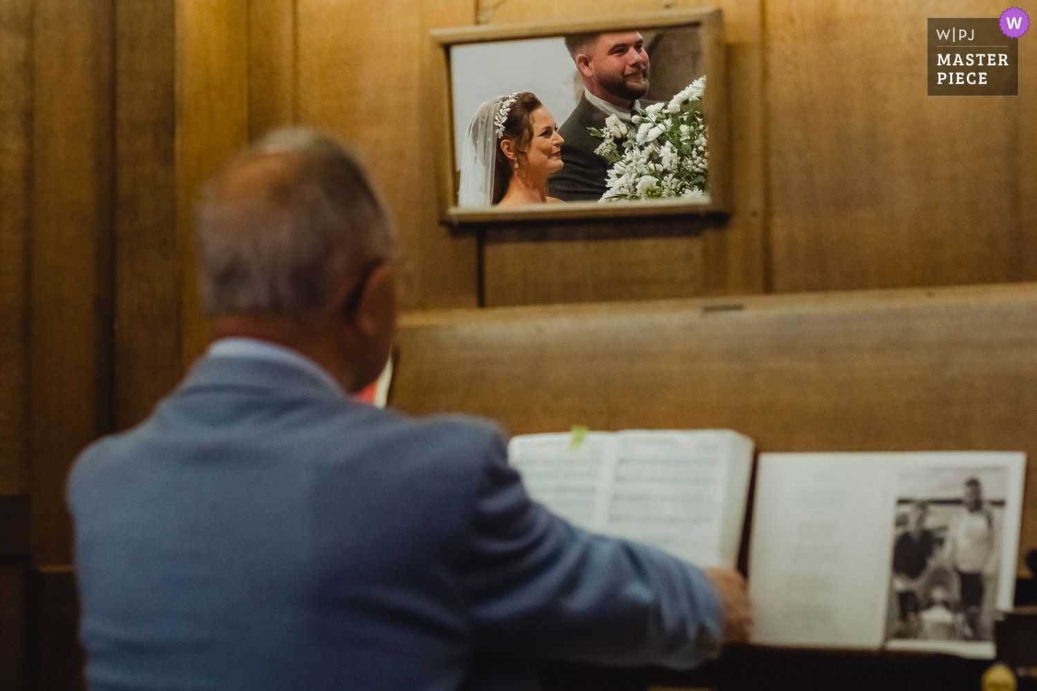 People gather around a wooden table examining documents in what appears to be a library or study room.