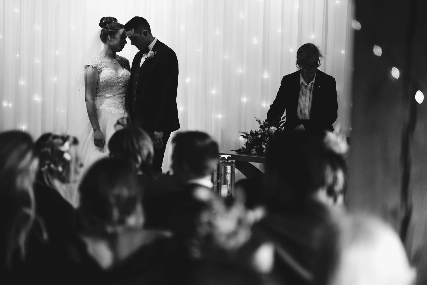 A romantic silhouette of newlyweds against a sparkly backdrop of fairy lights.