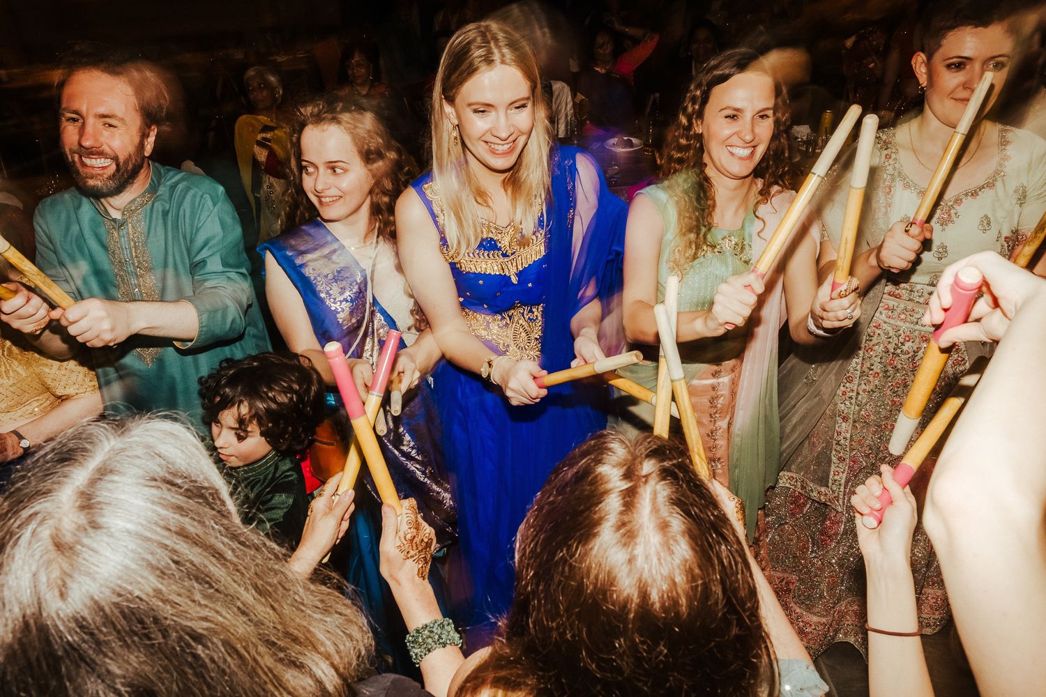 Large group of party guests dancing together in formal attire.