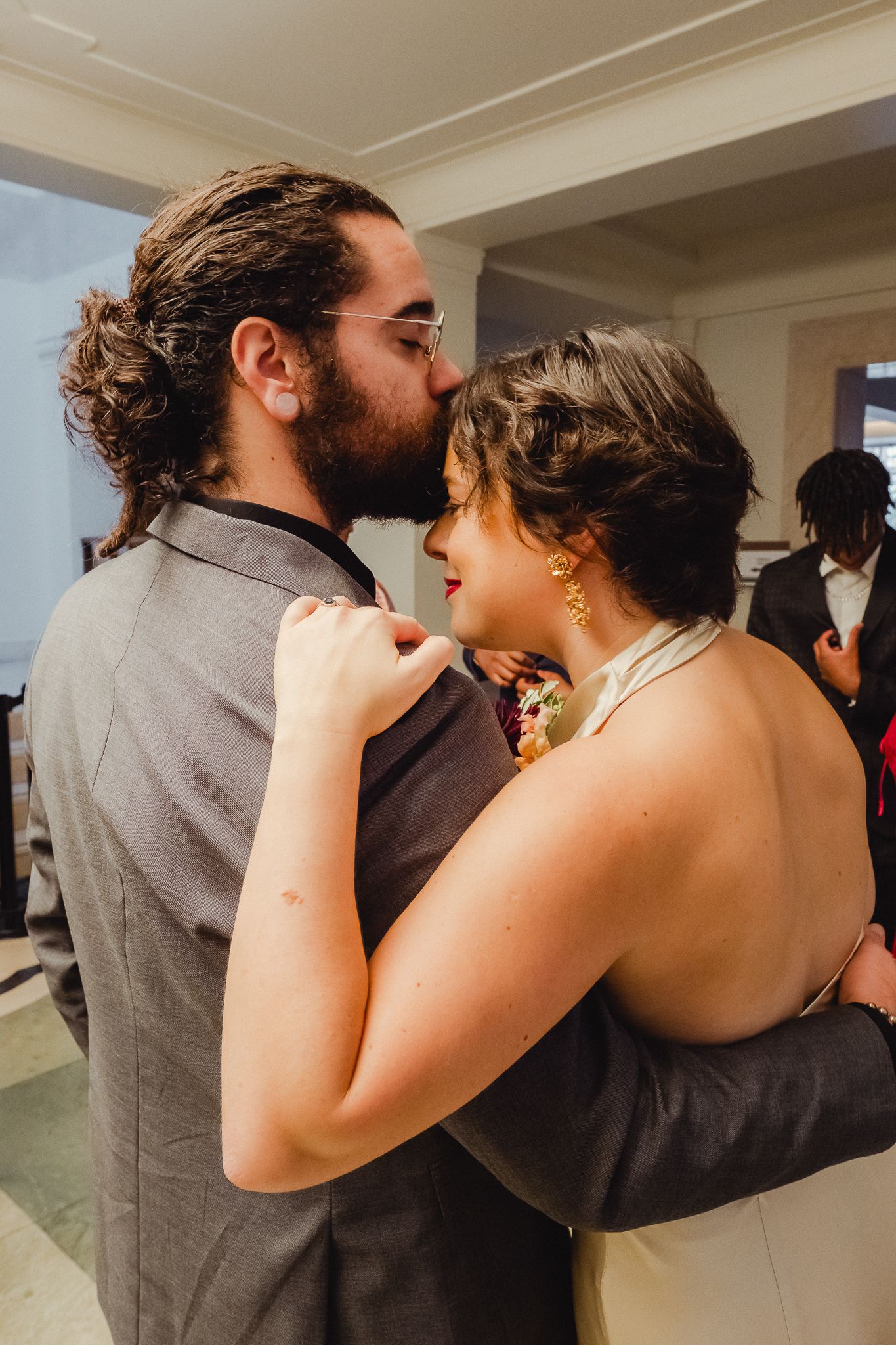 A romantic sequence of photos showing a couple sharing a tender kiss in an indoor setting.