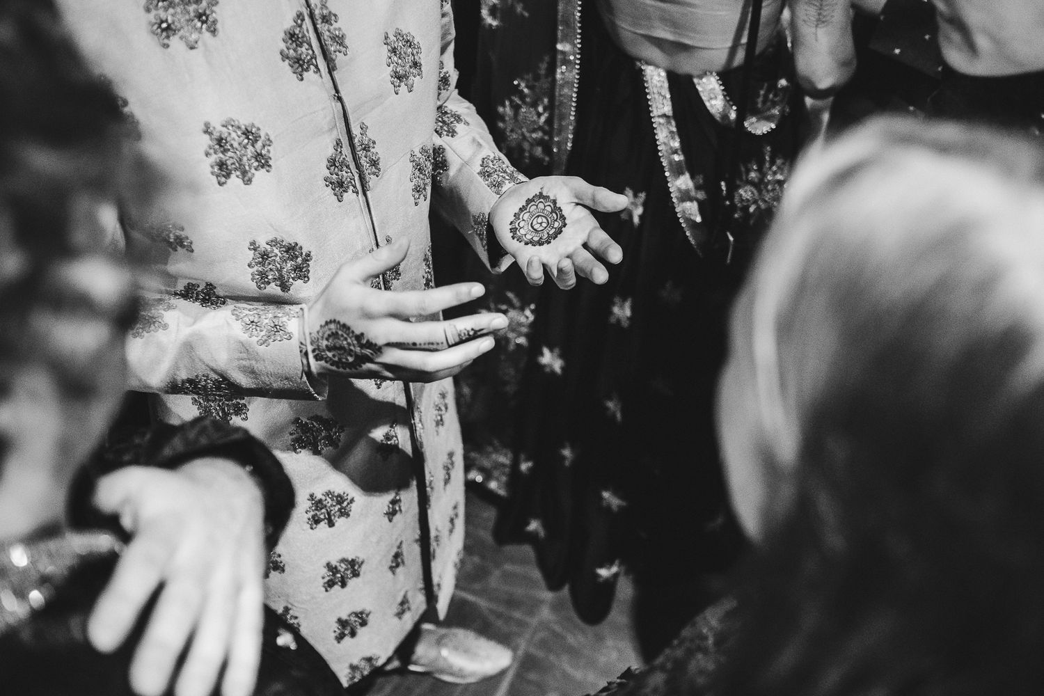 People dance and celebrate in a dimly lit indoor venue setting.