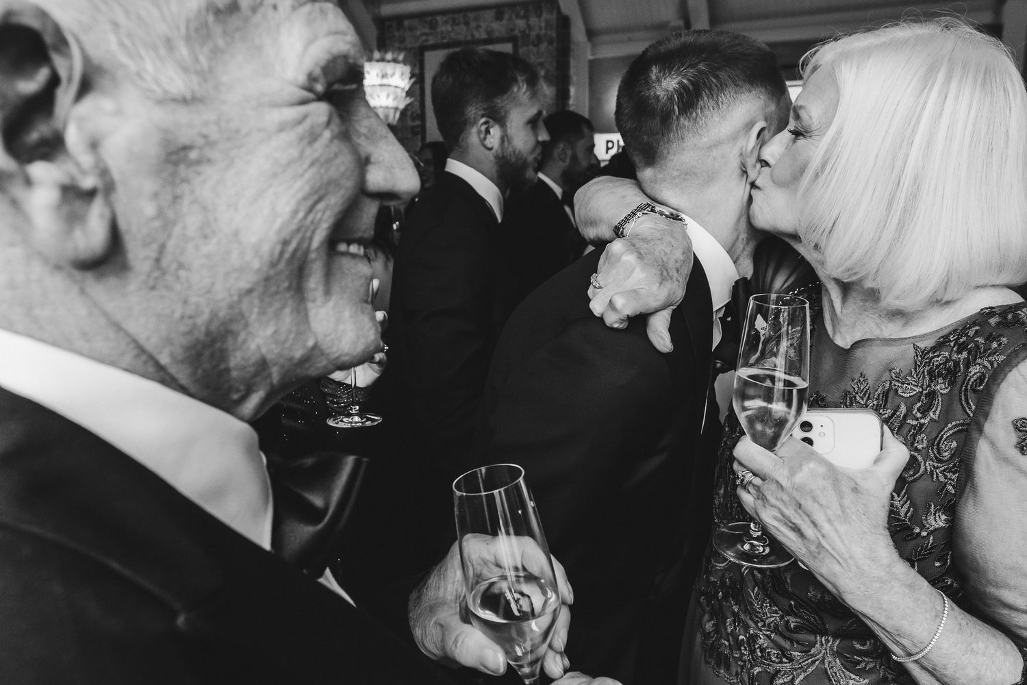A series of black and white photographs showing people drinking and toasting with wine glasses at a social gathering.