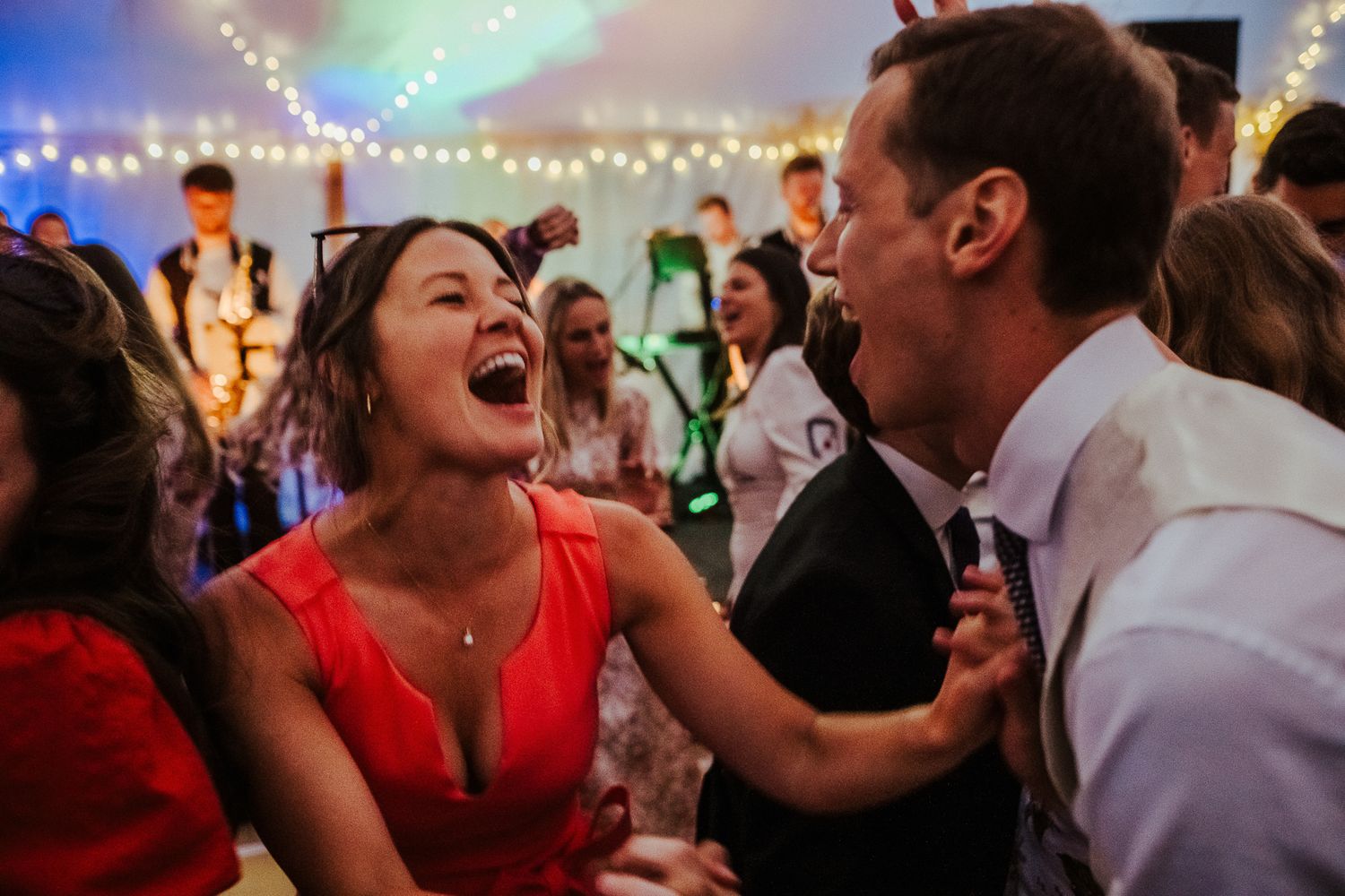 Lively dance floor moment captured during wedding reception celebrations.