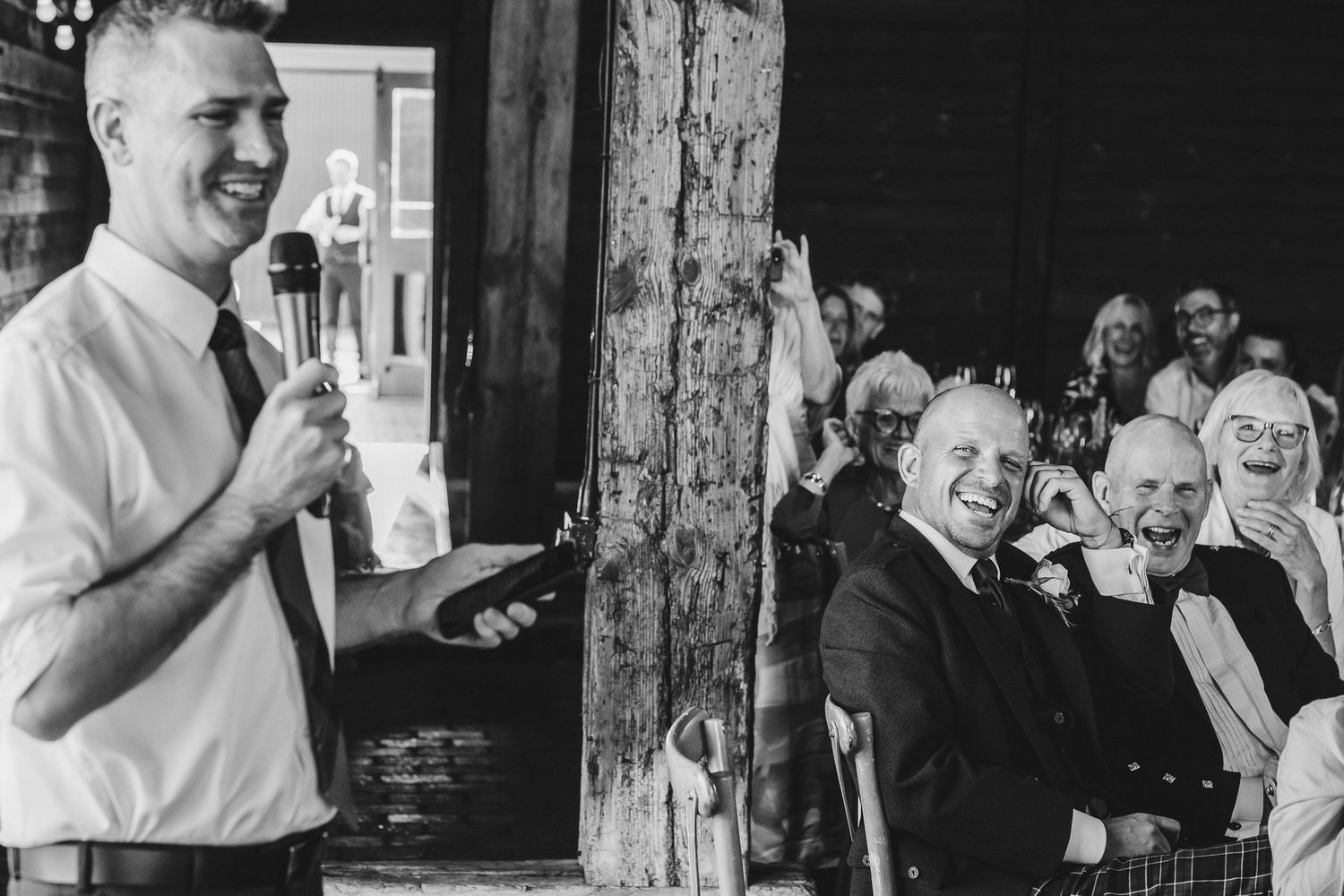 Black and white photo collage showing candid moments of laughter and joy at a wedding celebration.
