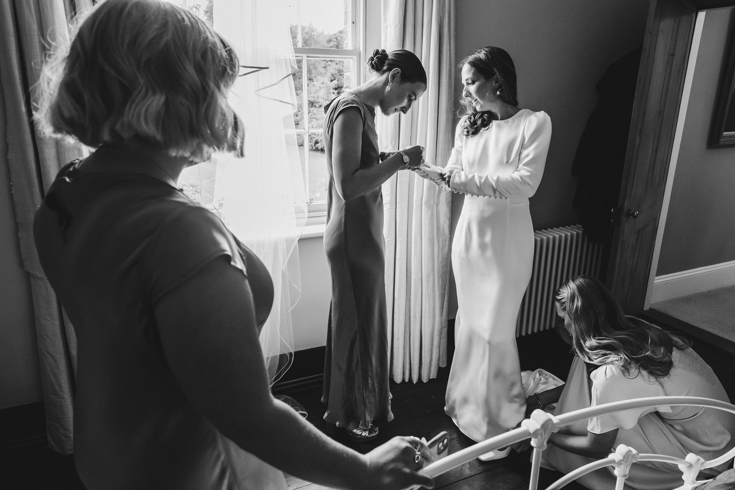 A series of black and white photos showing people working in a professional kitchen environment.
