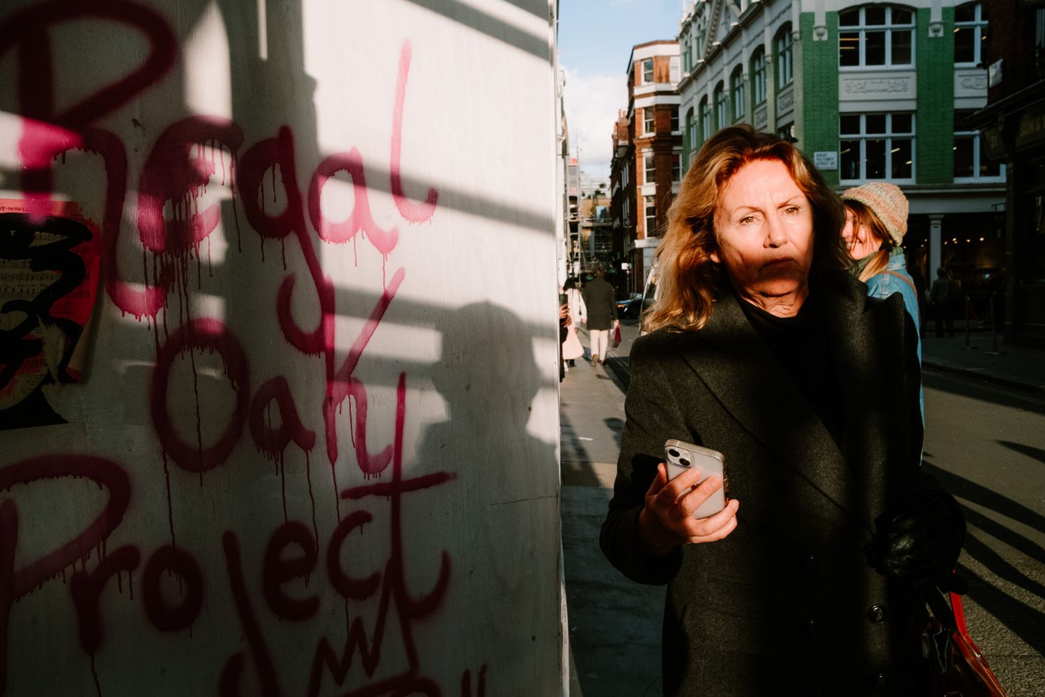 A series of connected urban street photos showing a person in black clothing against graffiti walls in moody lighting.