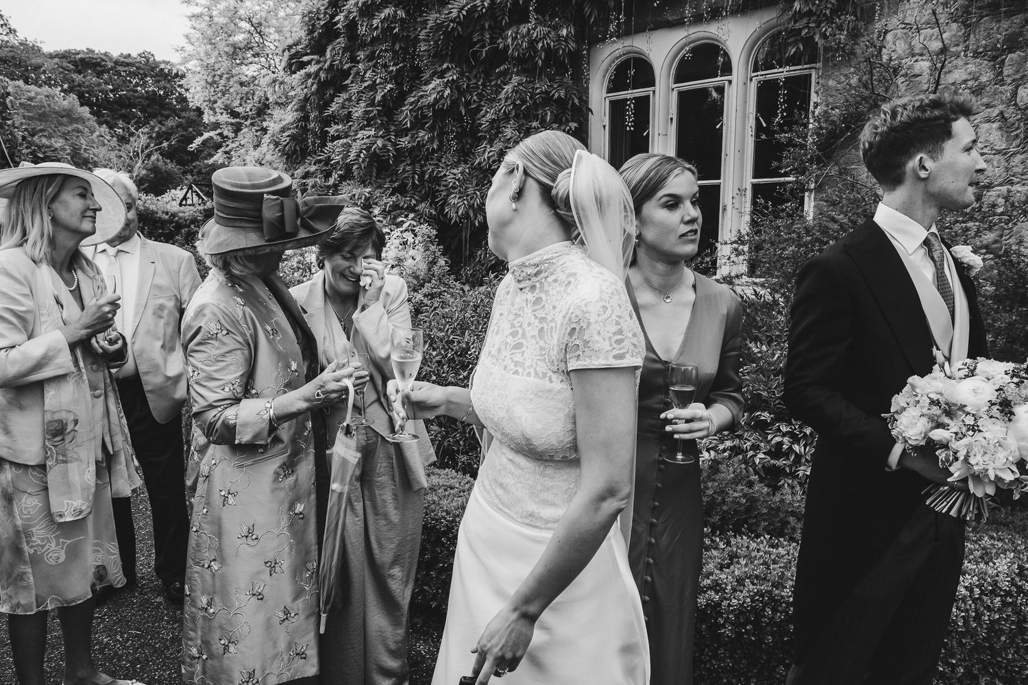 Black and white wedding photo collage showing intimate moments of celebration and dancing at an elegant outdoor venue.